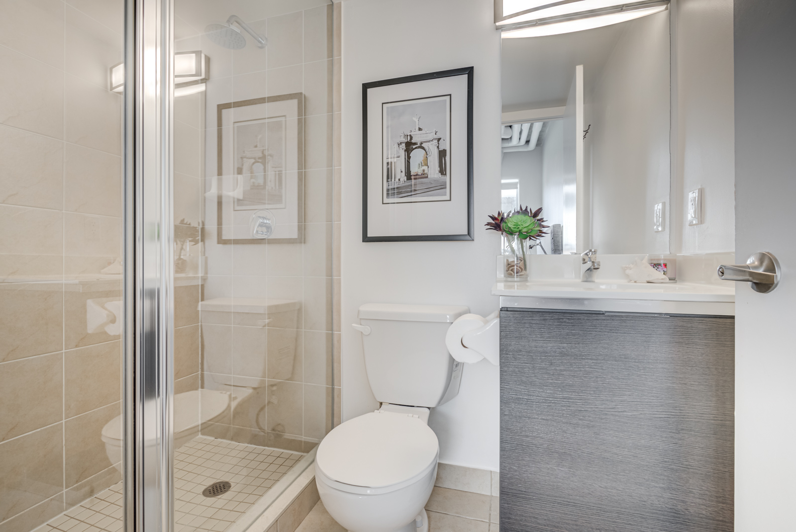 Master bath of 150 Sudbury St with standing shower, ceramic floors and big vanity.