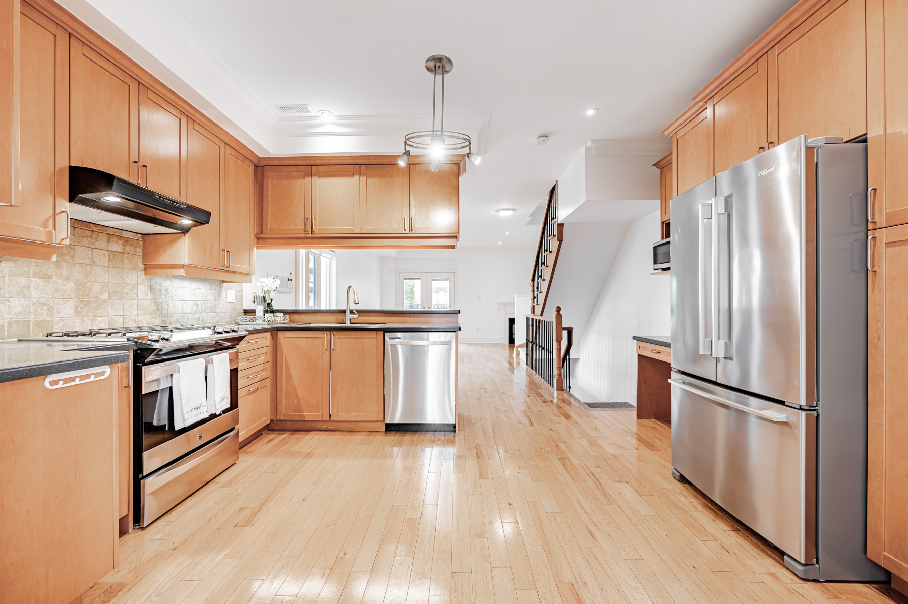 23 Annex Lane kitchen with wood cabinets, counters and floor.