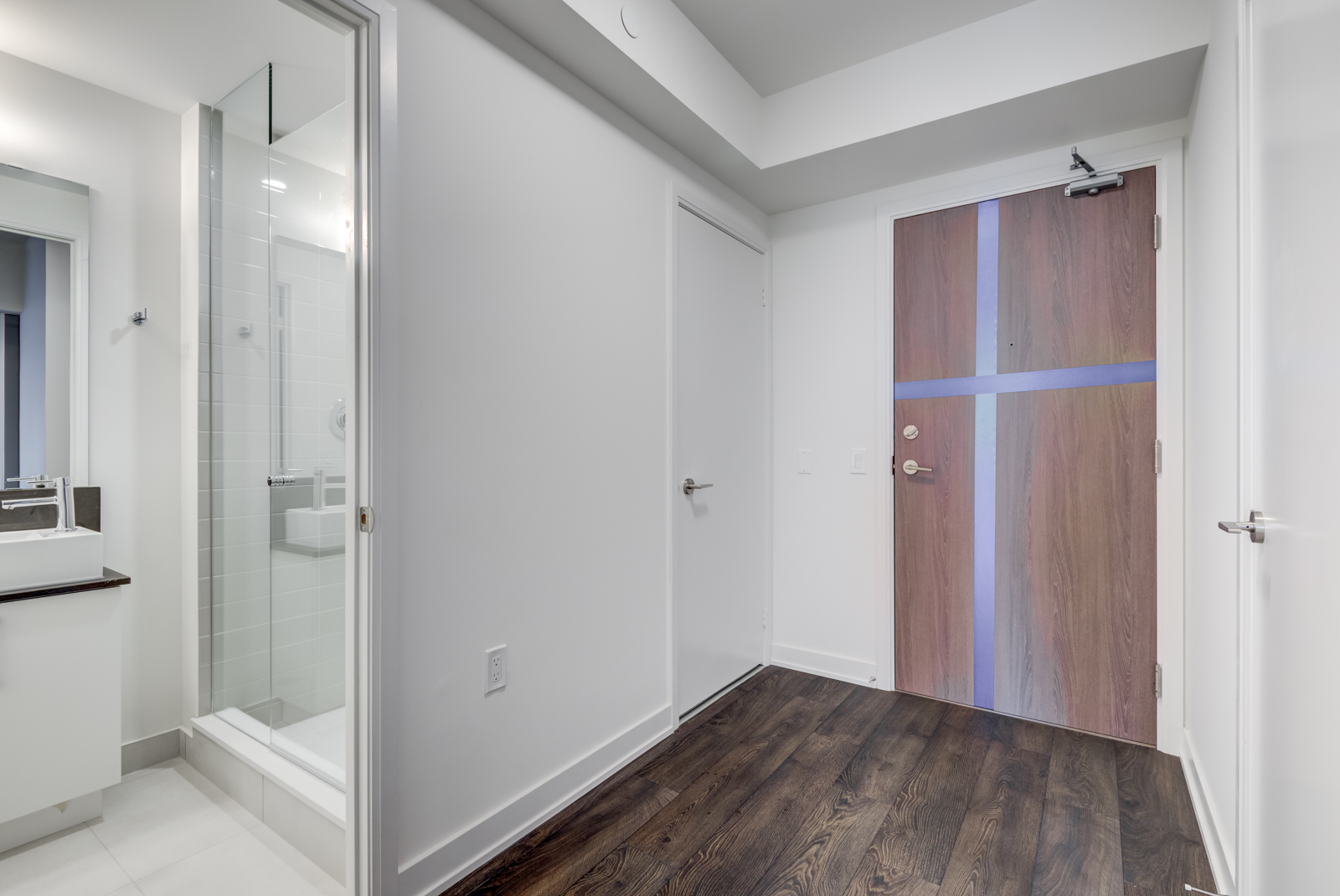 Second bathroom with open door; hallway and front entrance.