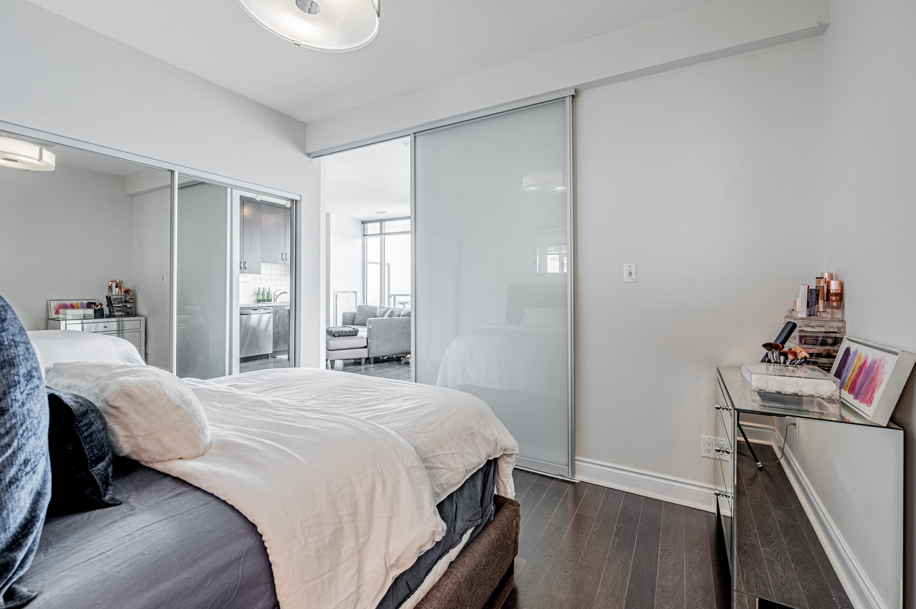 Condo bedroom with large mirror door closet on left side.