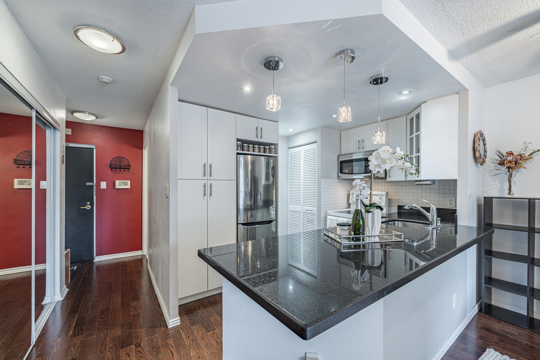 Condo kitchen with black granite countertops.