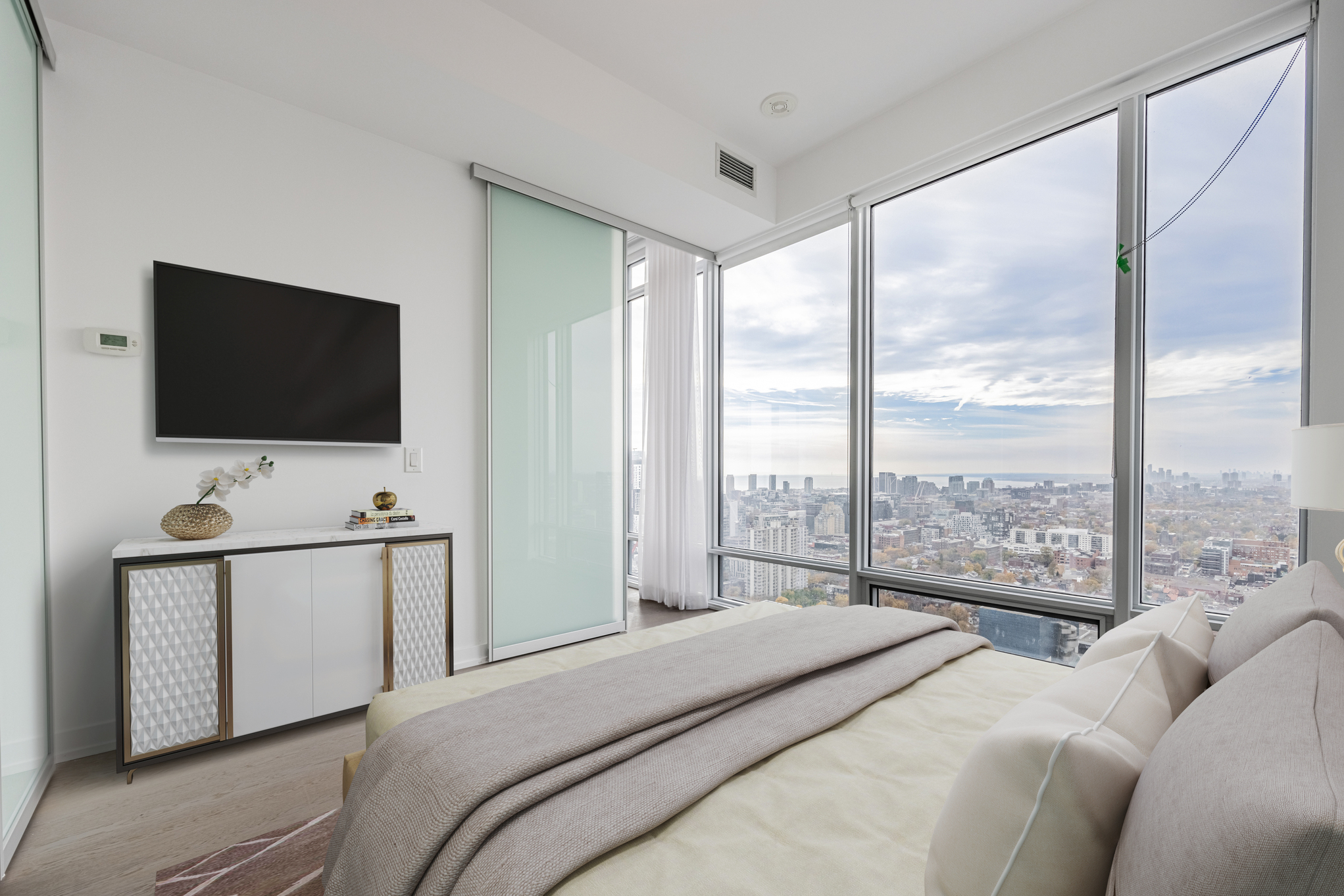 Condo bedroom with large windows.