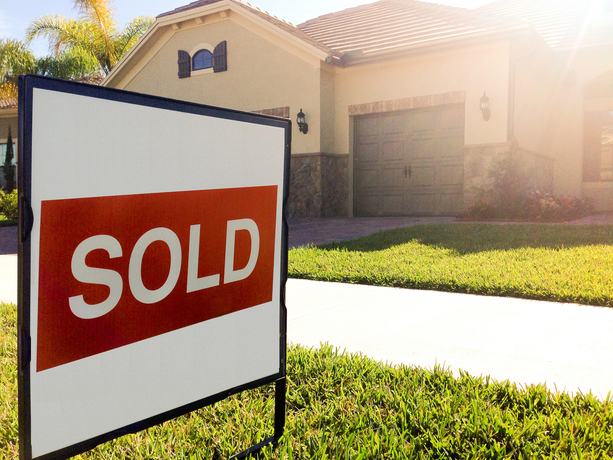 Sold sign on lawn in front of property. It takes so much more than MLS to sell a home.