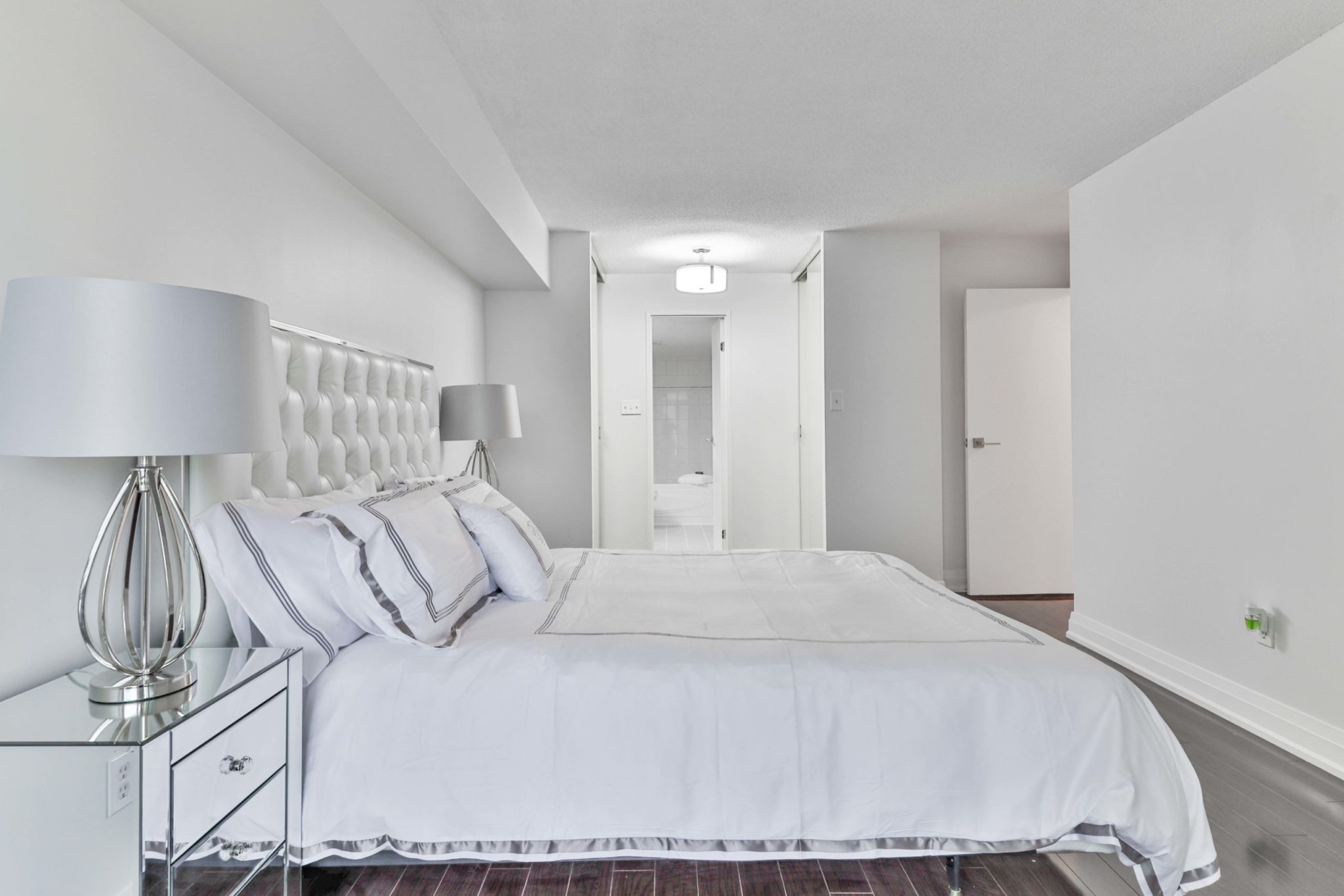 5 Rowntree Rd Unit 1404 master bedroom with gray walls and white bed.