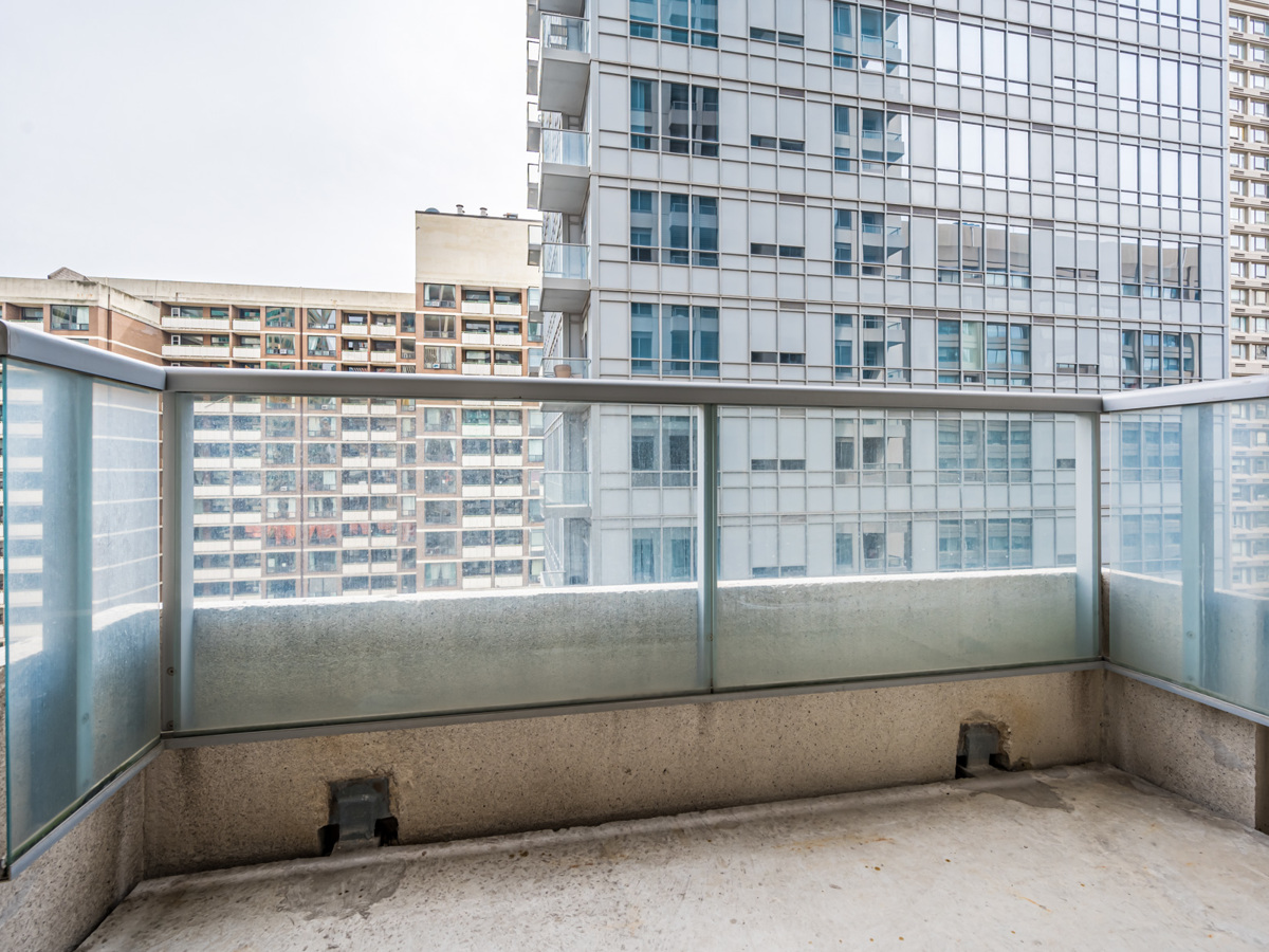 35 Balmuto St Unit 1407 balcony with concrete floors and glass panels.