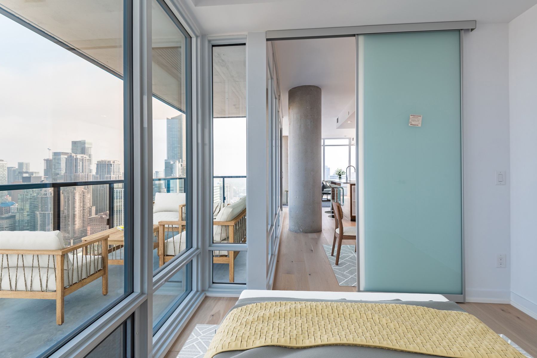 Brightly-lit bedroom next to balcony.