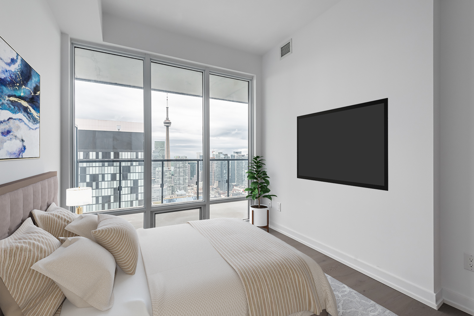 Condo bedroom with view of CN Tower.