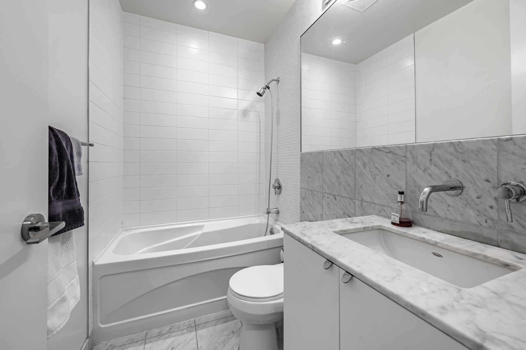 Ensuite bath with gray walls, floors, counters - 380 Macpherson Ave # 517.
