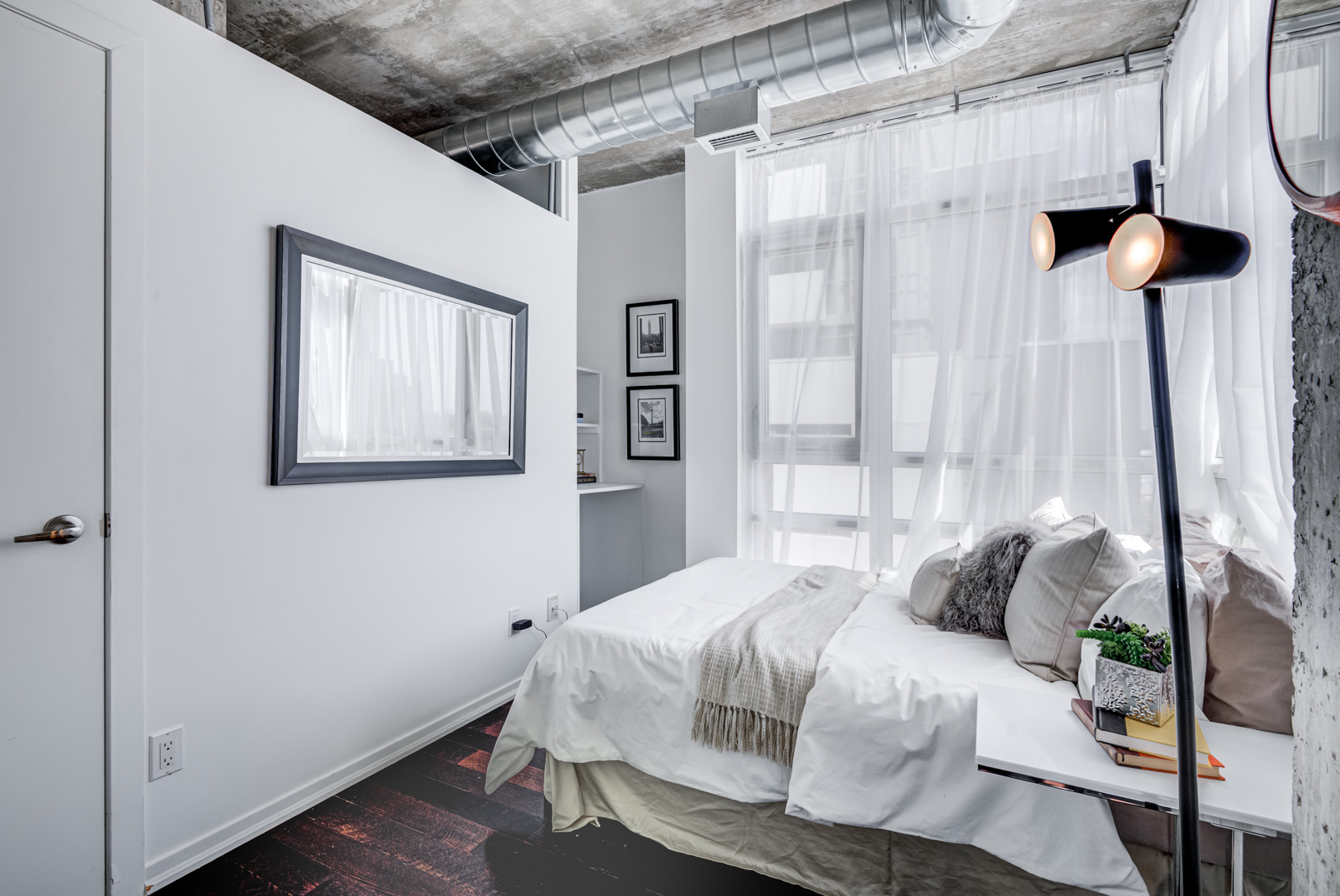 Industrial-chic bedroom of 150 Sudbury St Unit 511.