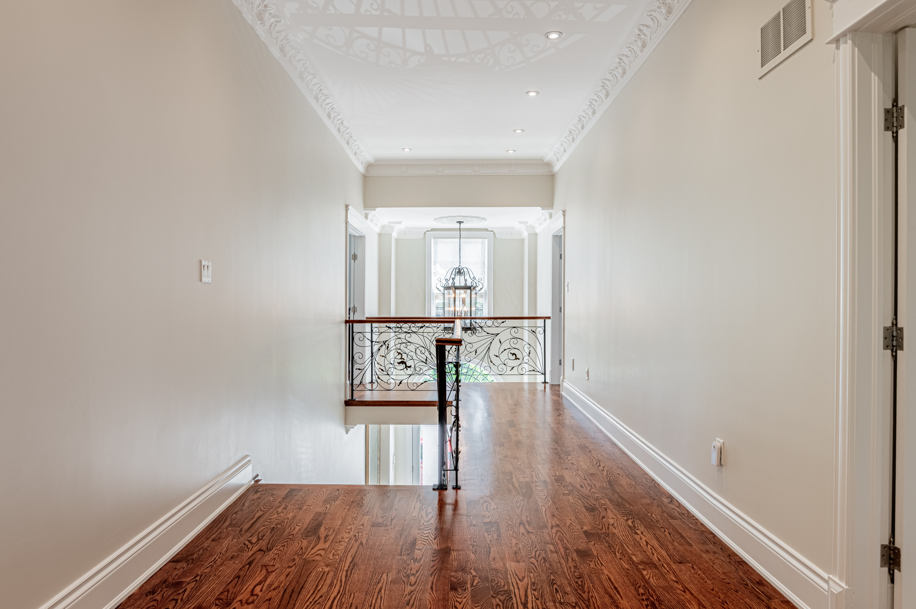 House hallway with hardwood floors, potlights and iron rails – 12 Highland Hill.
