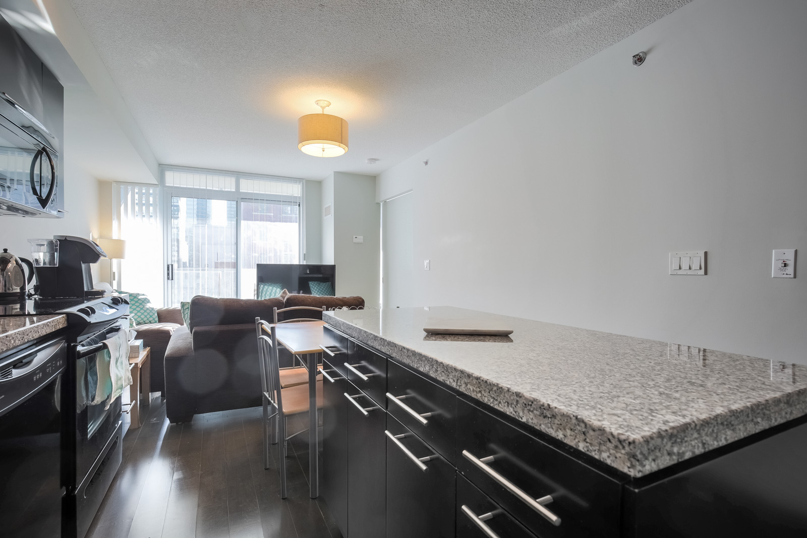 A view of the condo's granite counter-tops and kitchen island