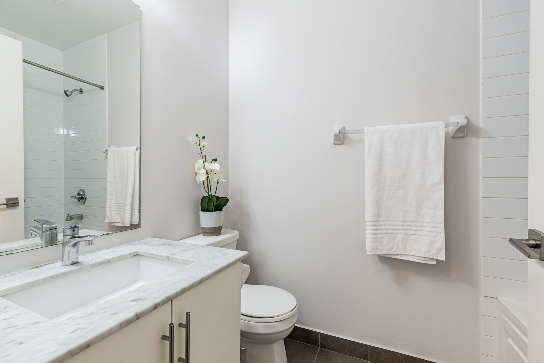 Newly painted gray 3-piece bathroom of 23 Glebe Rd W Unit 918.