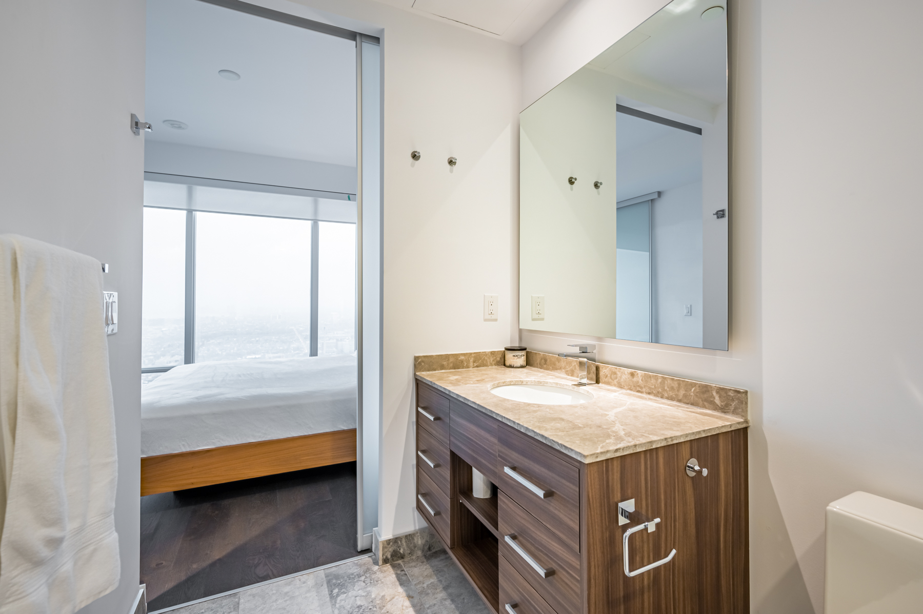 Custom-built vanity with large mirror and soft-close drawers.