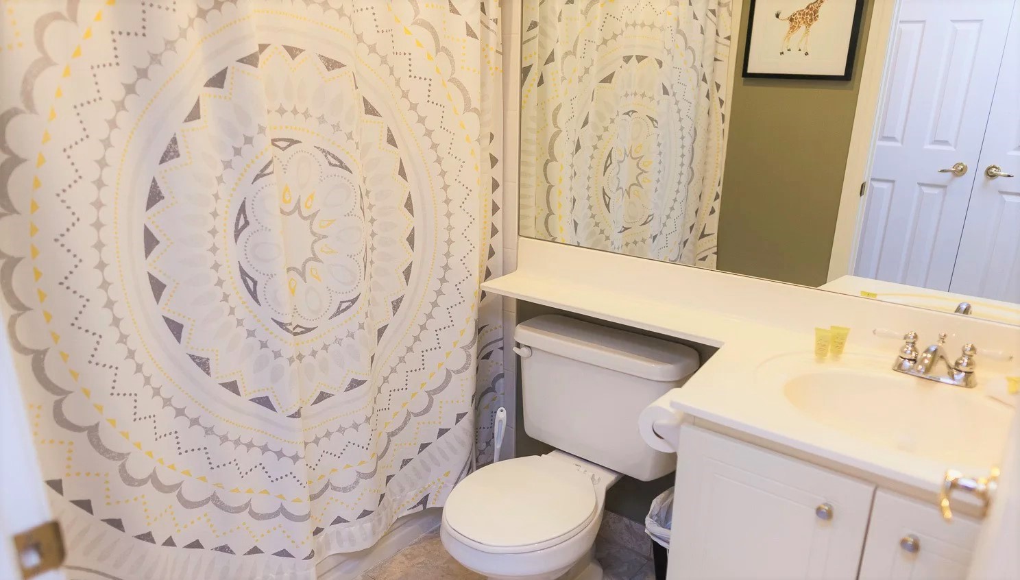 Bathroom with floral shower curtain.