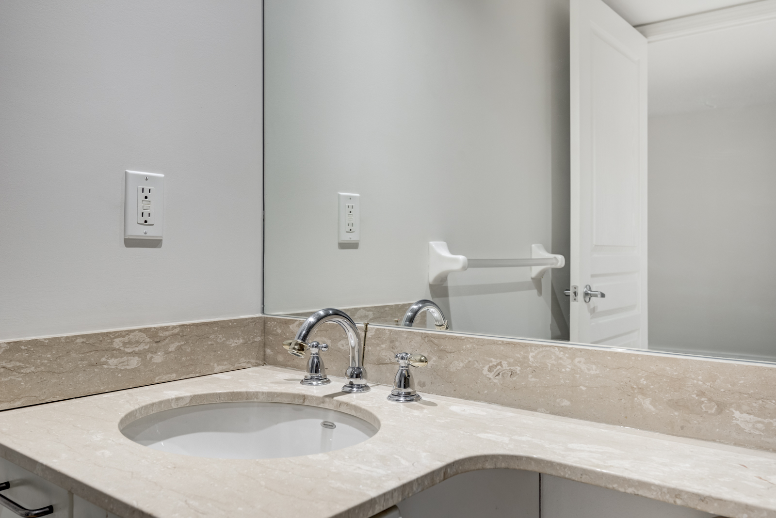 Close up of bathroom sink with circular bowl and silver faucet.