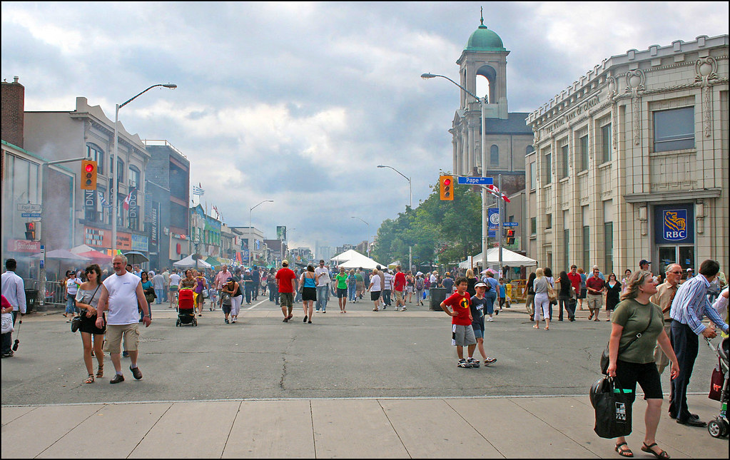 Pedestrians on Pape Ave, Toronto on sunny day.