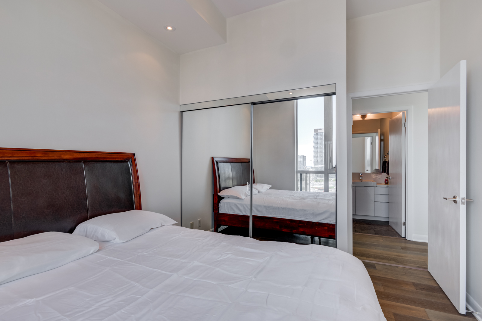 Second bedroom with mirror closet doors - Victory Lofts Penthouse Suite in 478 King St W Toronto.