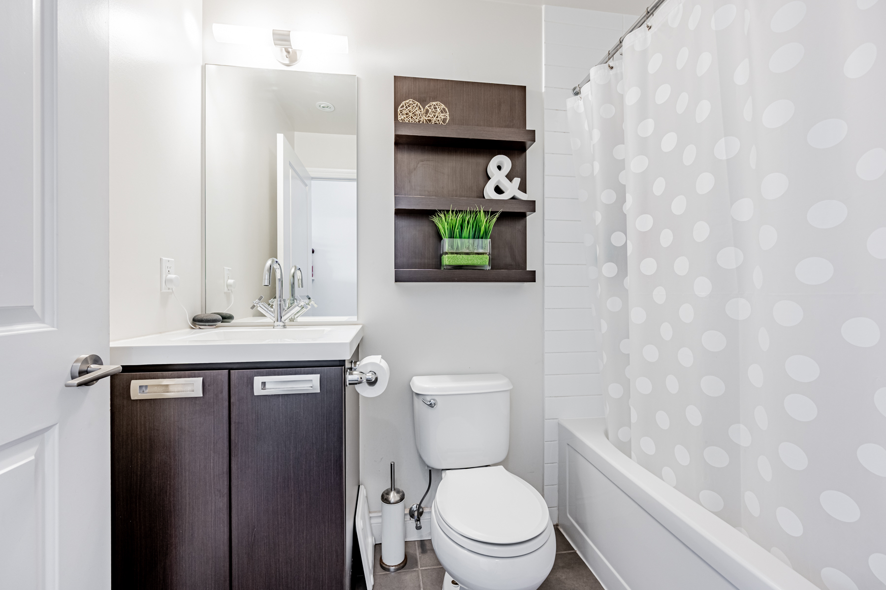 90 Stadium Rd Unit 824 bathroom with ceramic floors, wall-mounted shelves and soaker tub.