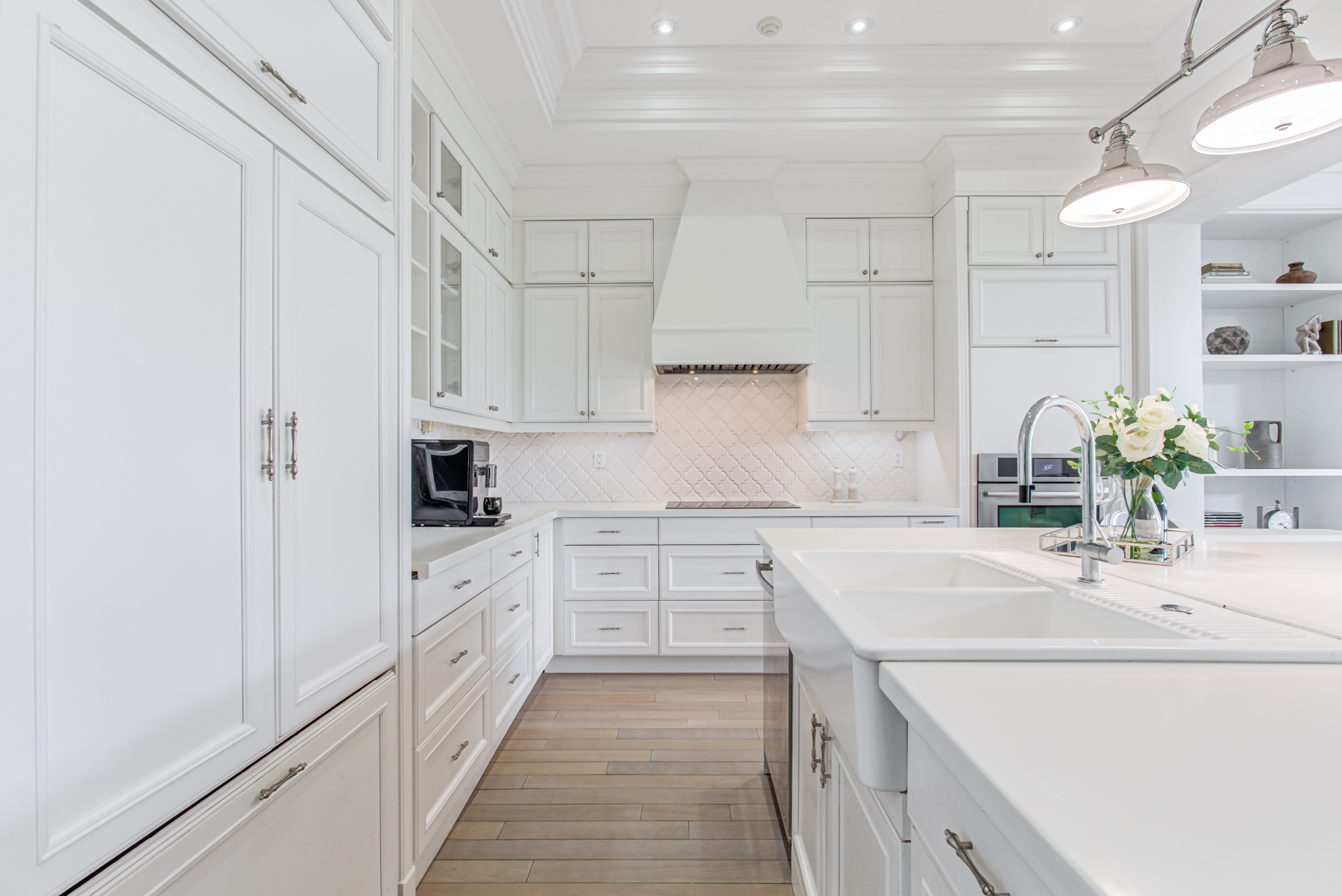 Gorgeous kitchen with quartz counters and stylish ceramic back-splash.