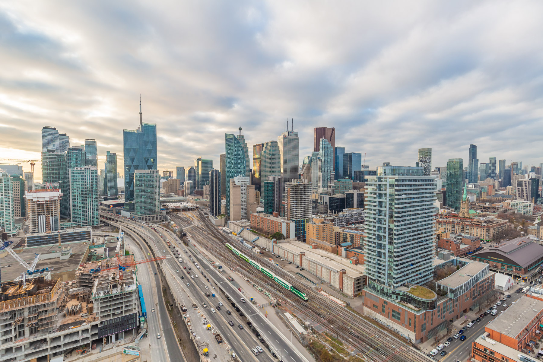 Toronto skyline with buildings, CN Tower needle, construction, highways and Go Train.