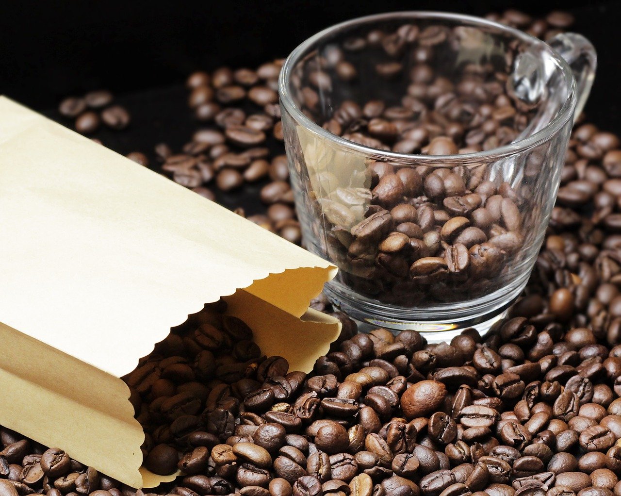 Paper bag spilling coffee beans.