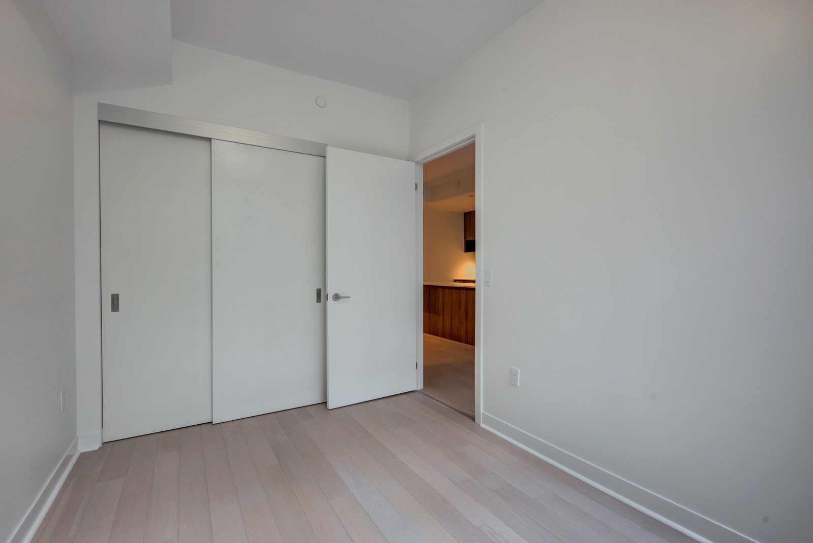 Closed white closet doors of master bedroom.