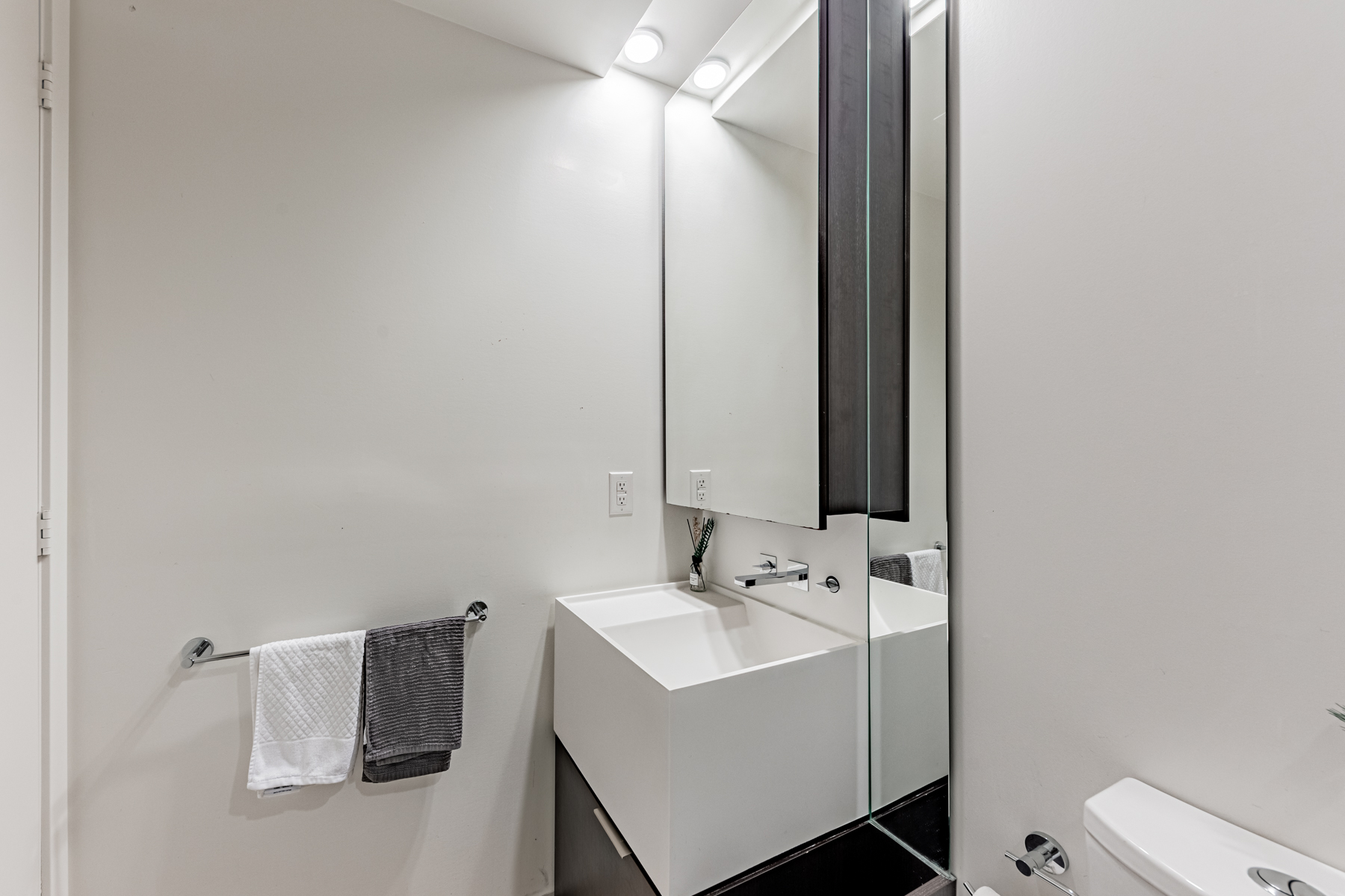 Corian sink with storage and medicine cabinet.