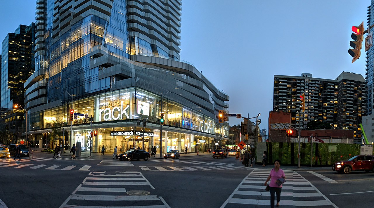 Facade of One Bloor Condos on Yonge and Bloor at night.