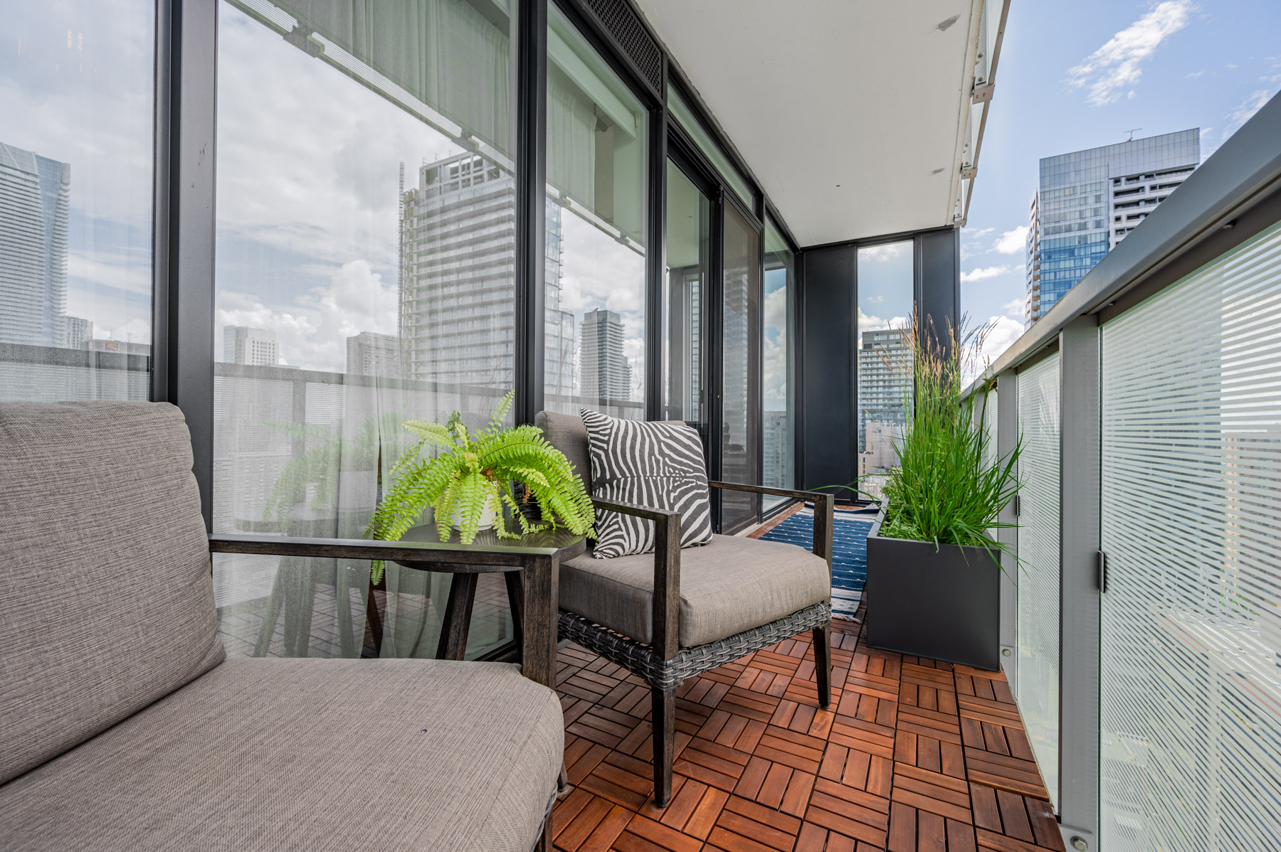 28 Wellesley St Unit 3009 balcony with parquet floors and furniture.