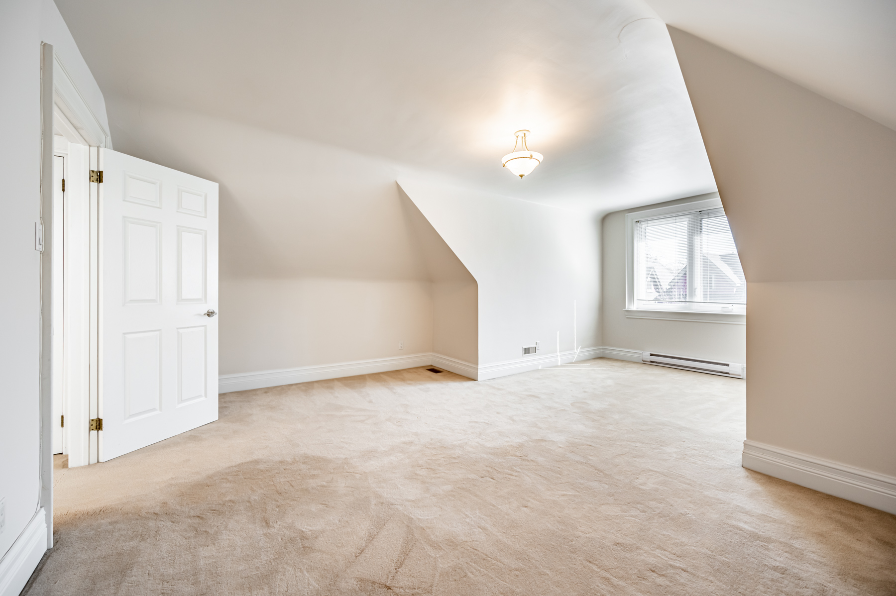 Bedroom lit by large window.