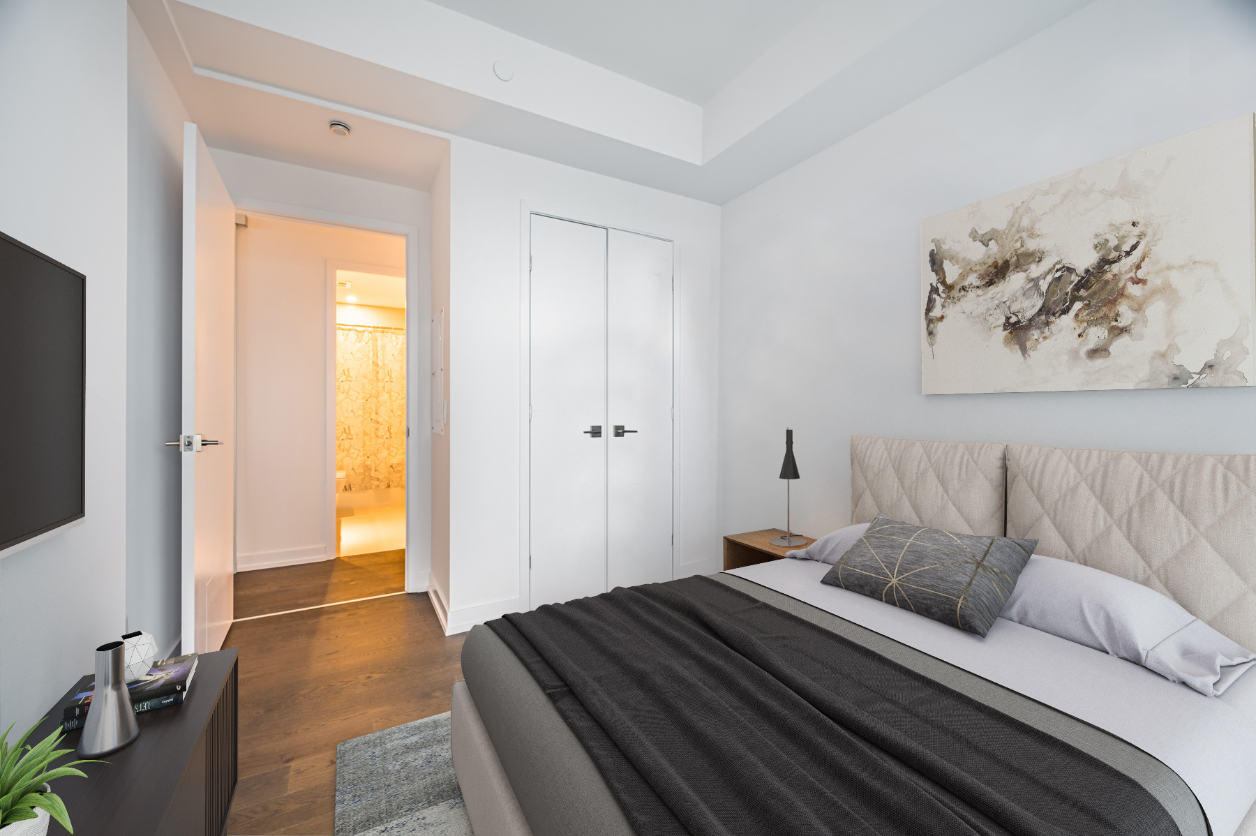 Condo bedroom with hardwood floors, gray walls and large closet.