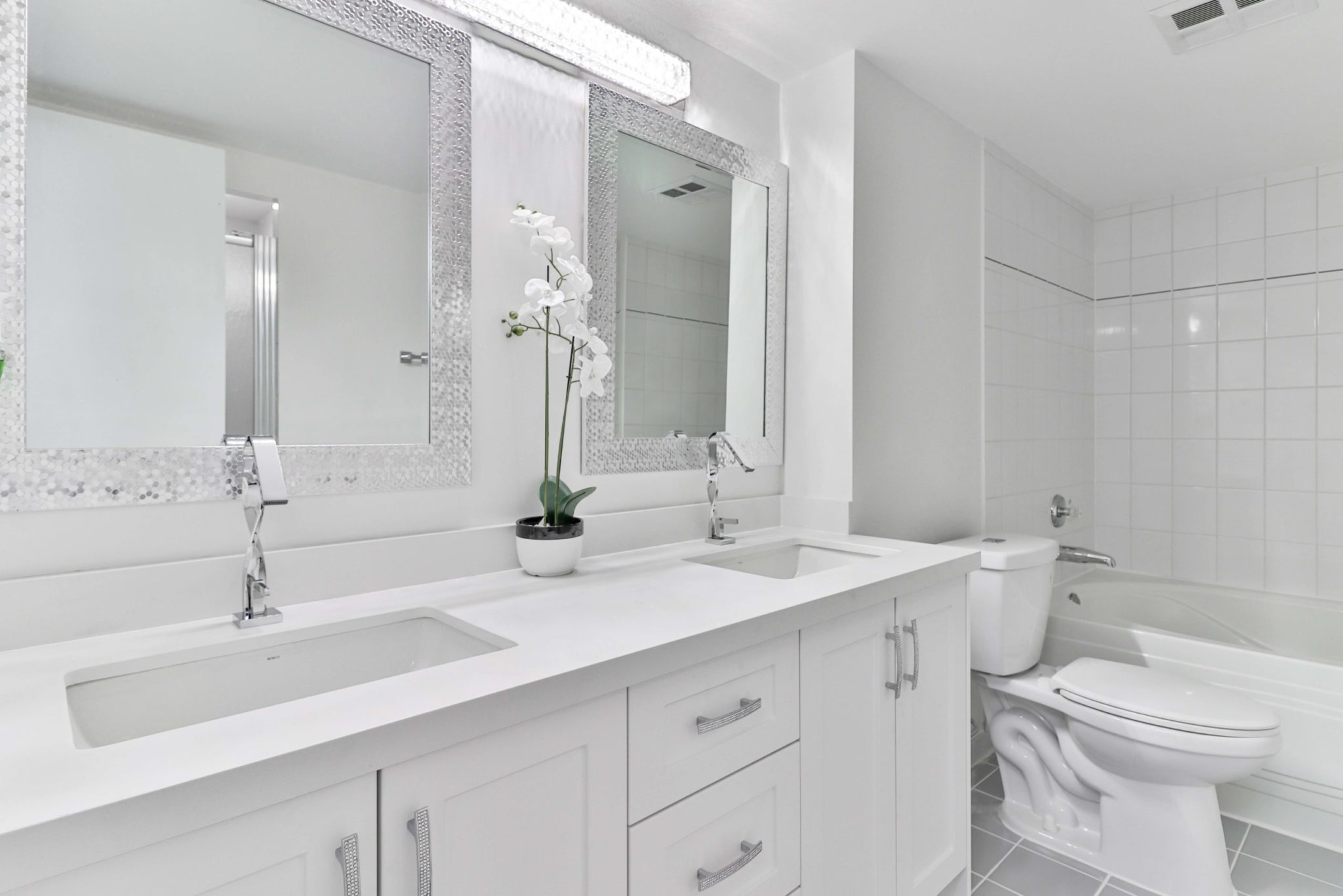 Newly renovated 5-piece bath with new cabinets, vanity, toilet and tub.