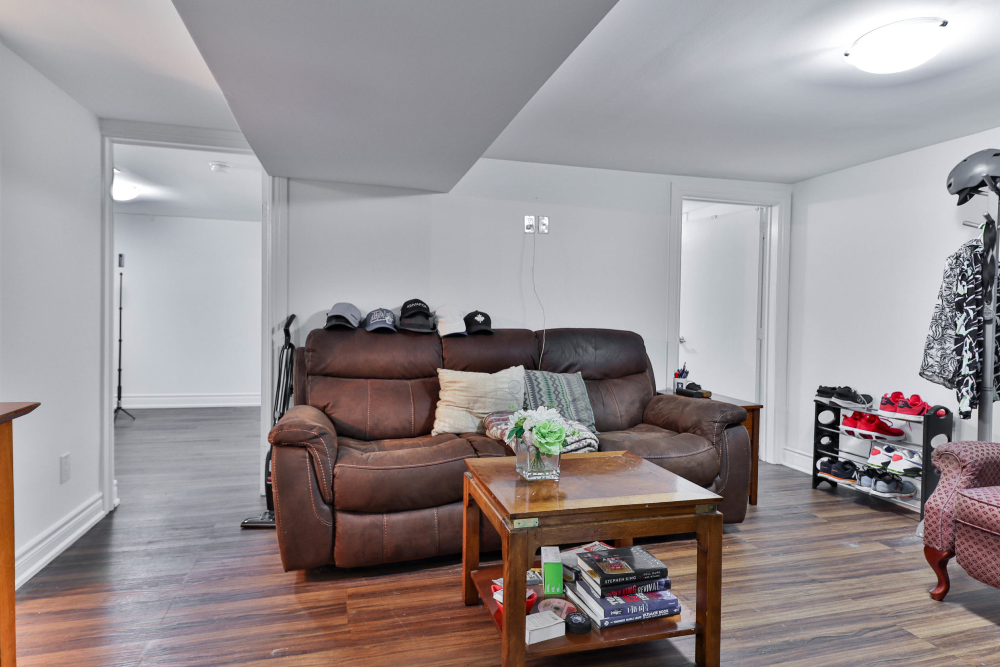 117 Phillip Ave finished basement with laminate floors, gray walls and ceiling lamps.