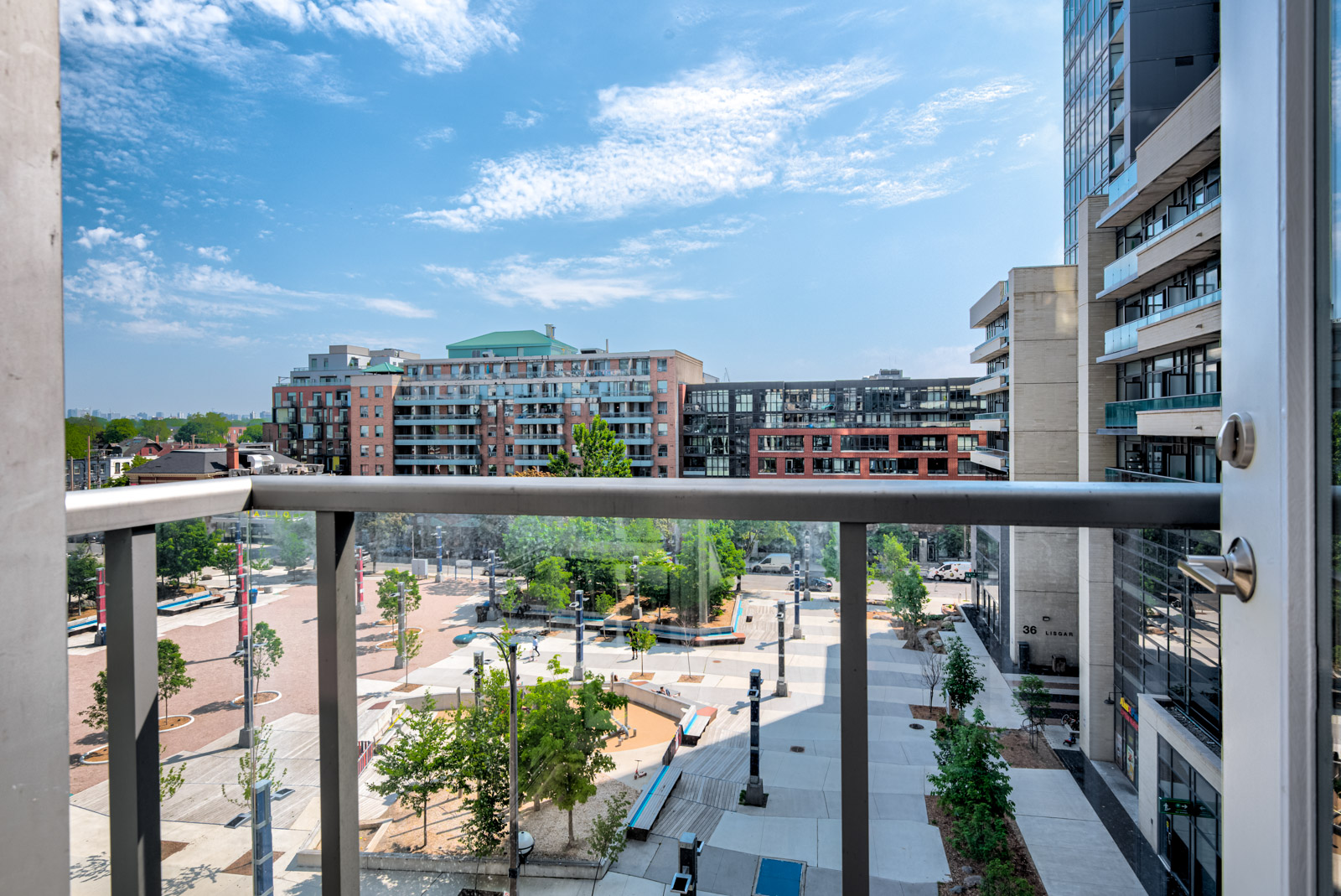 150 Sudbury St balcony with glass panels overlooking Lisgar Park.