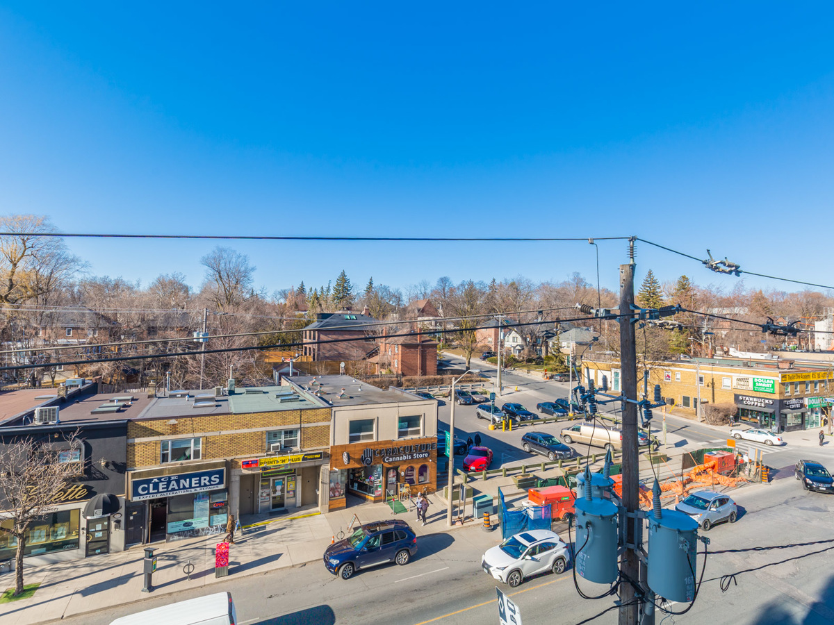 View of shops, cars and pedestrians on Eglinton Ave.