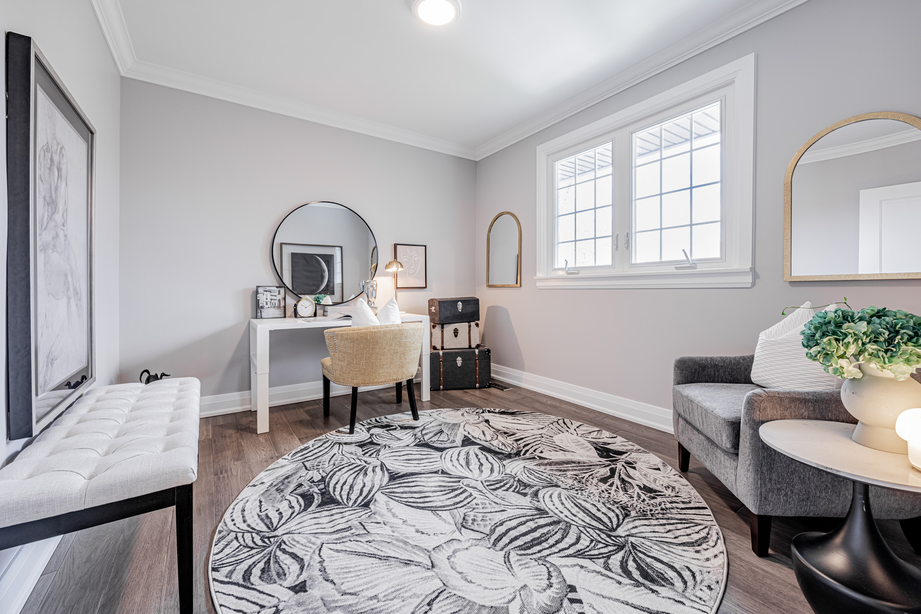 Bedroom with newly painted walls and wide-plank hardwood floors.