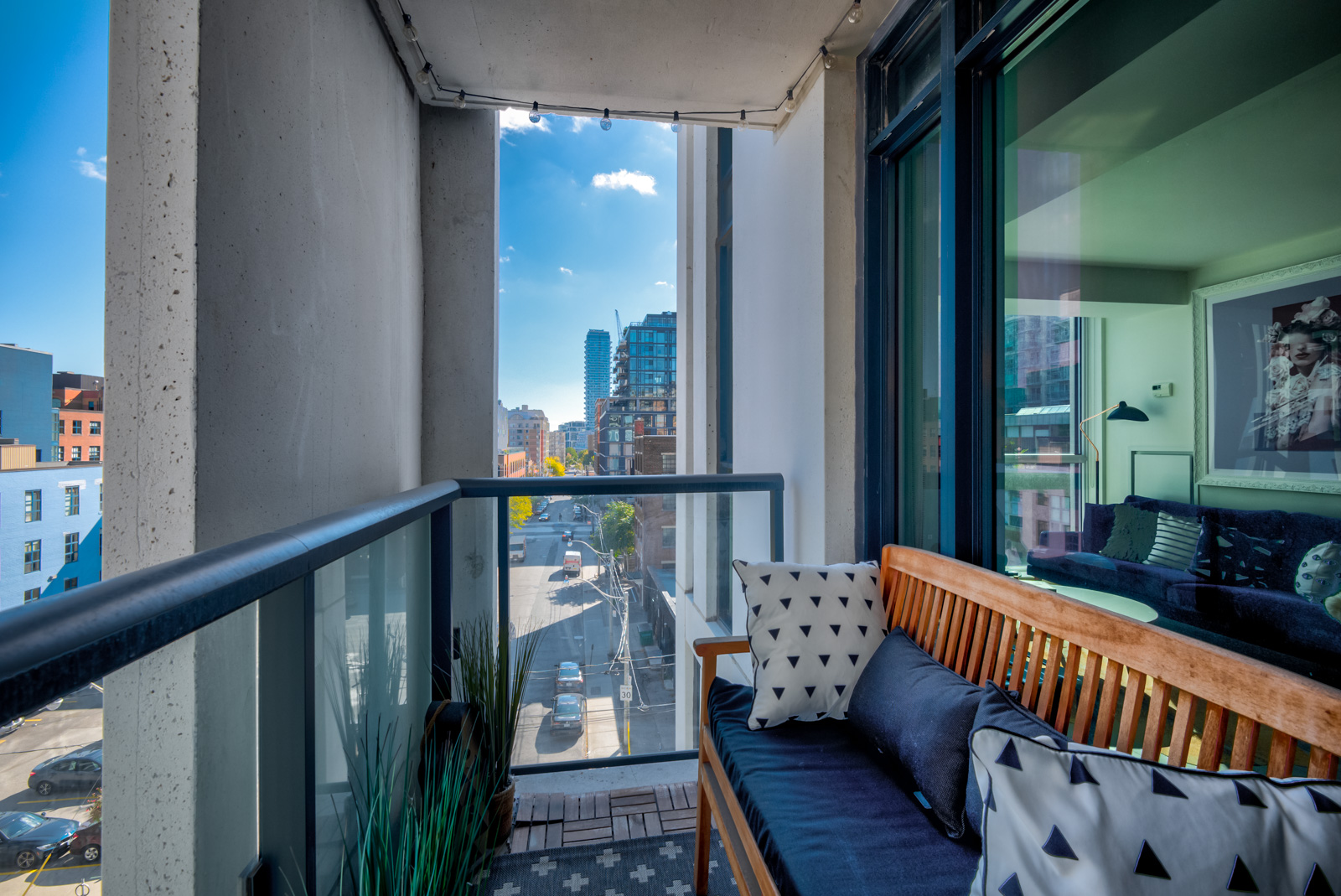 Balcony with glass-panels and bench at Ivory condos.