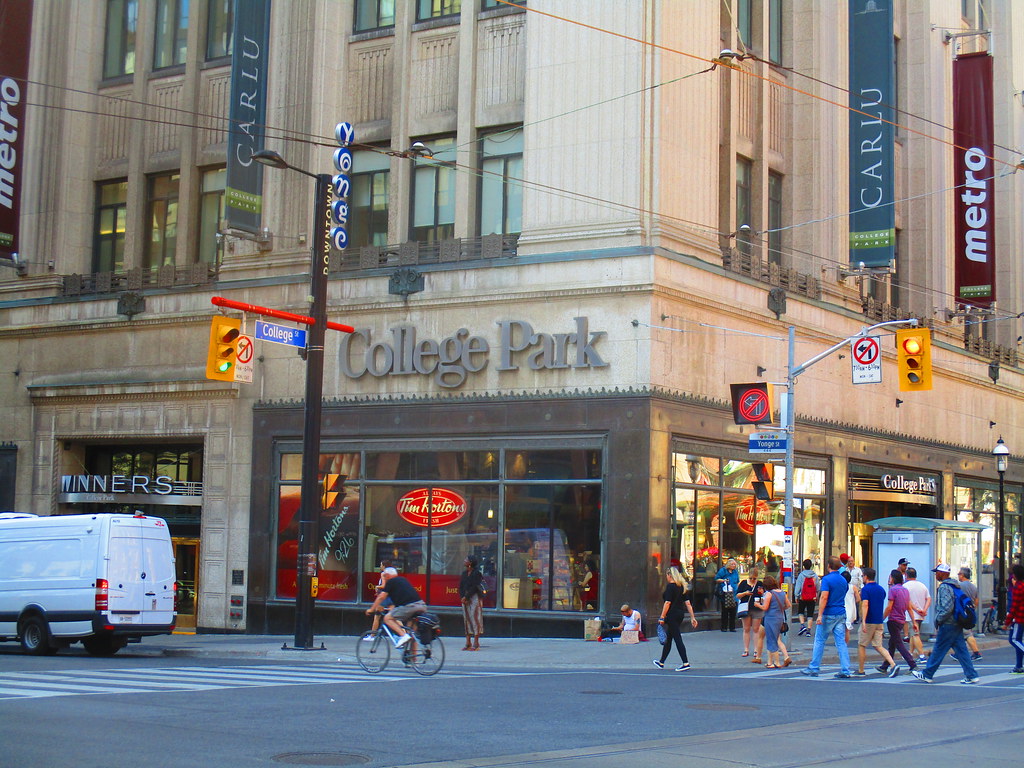 College Street Toronto with Winners, Yoga studio, people and traffic.