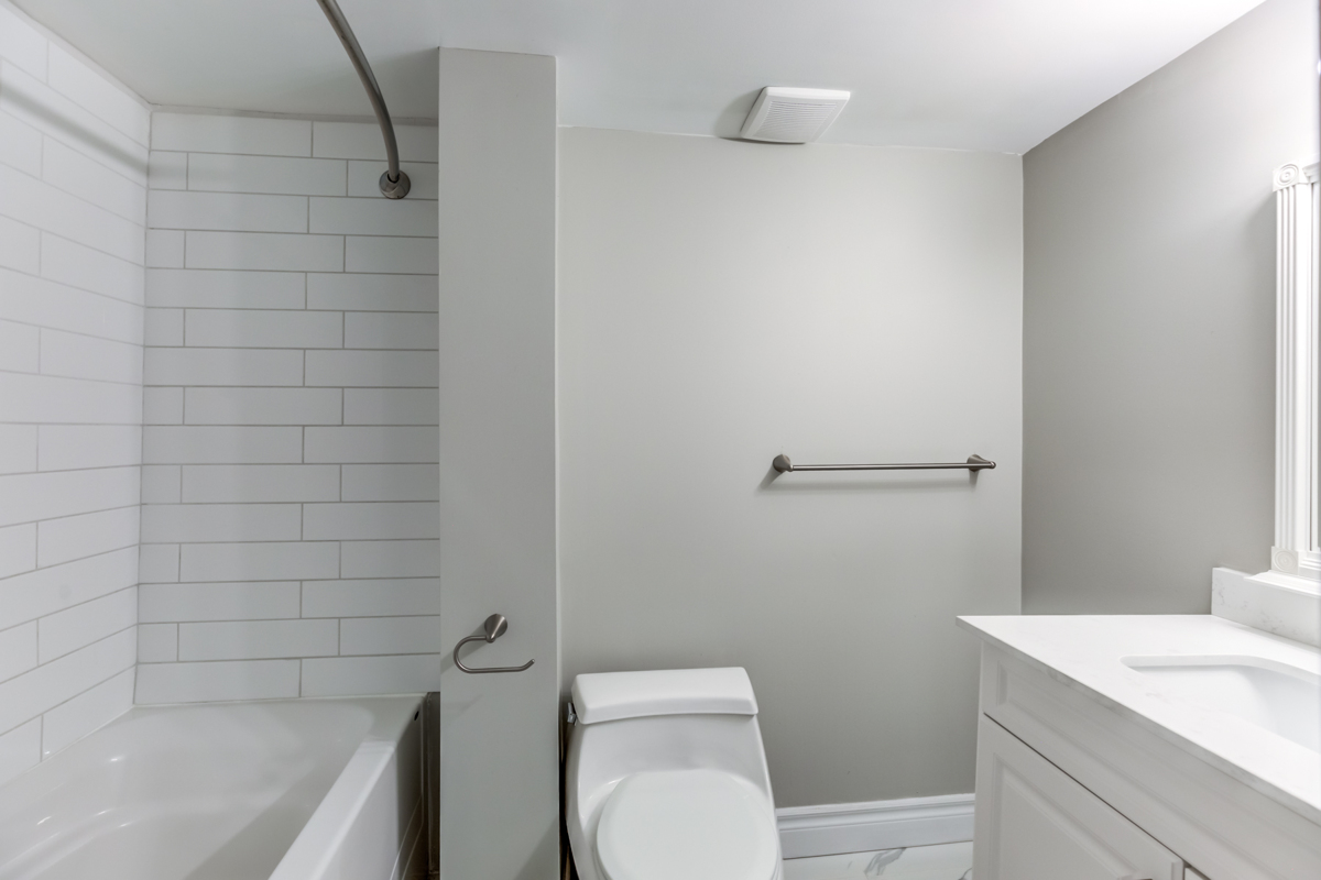 Bathroom with gray and white walls, bathtub and sink – 54 Huntington Ave.