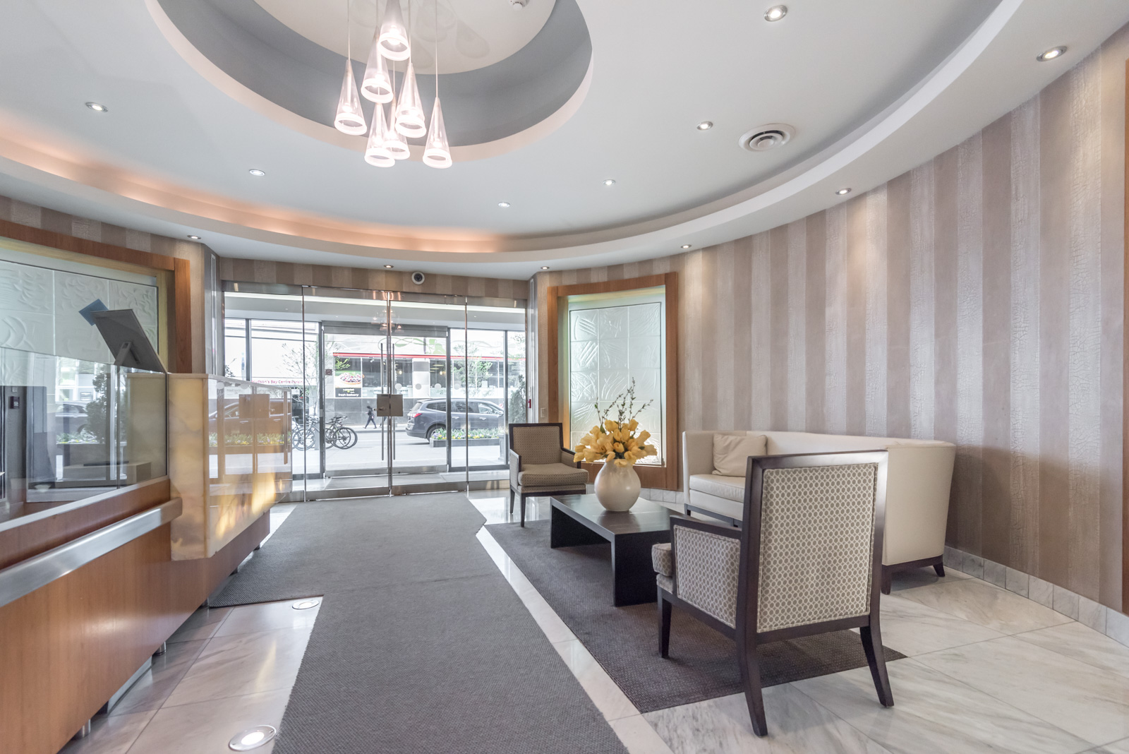 Elegant lobby and concierge desk of 85 Bloor Condos in Toronto.
