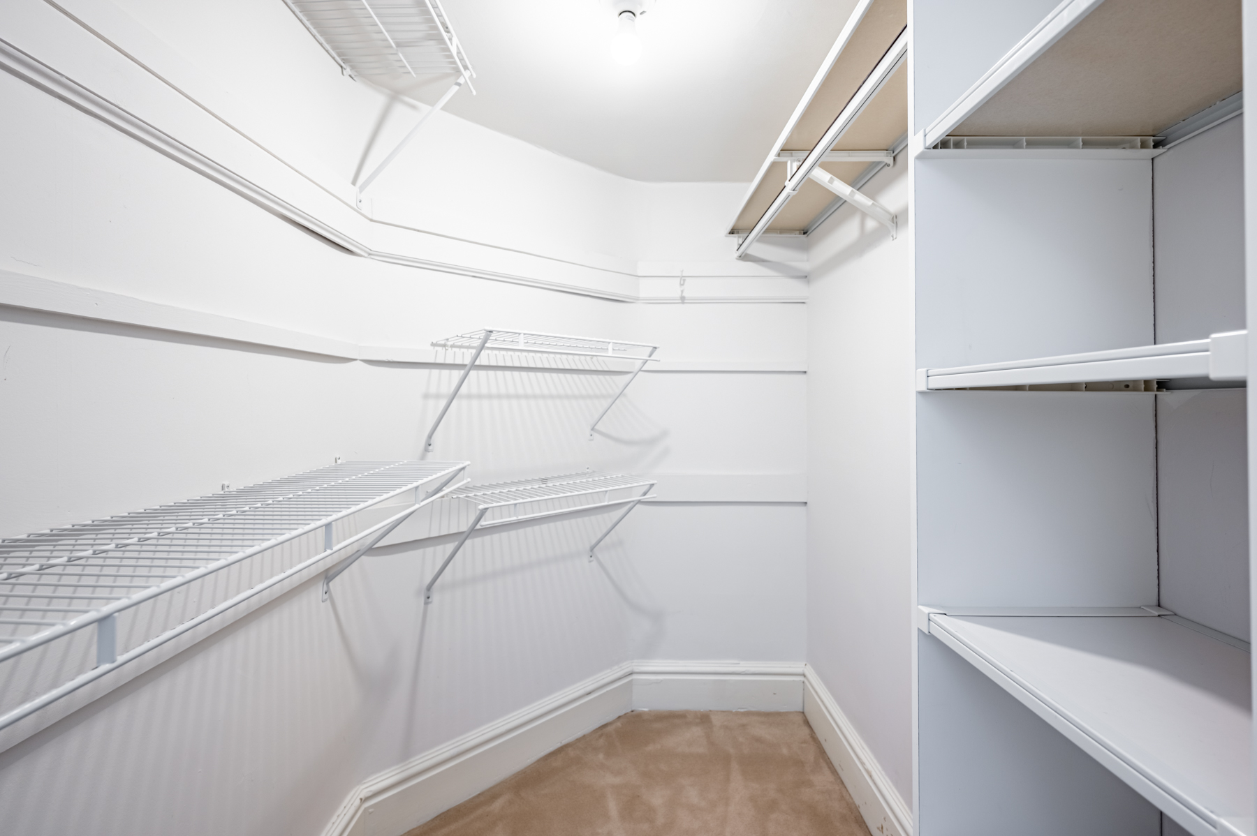 Walk-in closet with wire shelves and compartments.