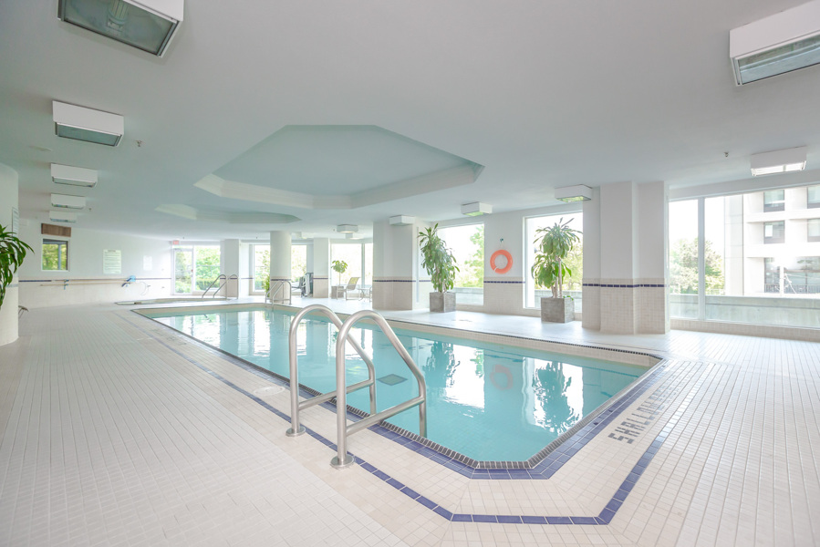 Indoor swimming pool and salt water pool in white facility at Bellagio on Bloor Condos, Toronto.