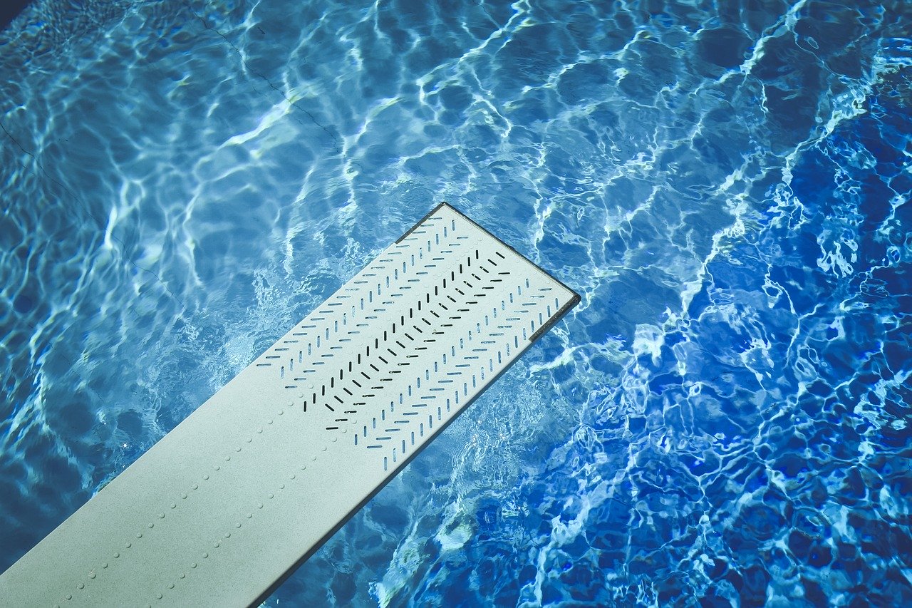 Top down view of swimming pool and diving board.