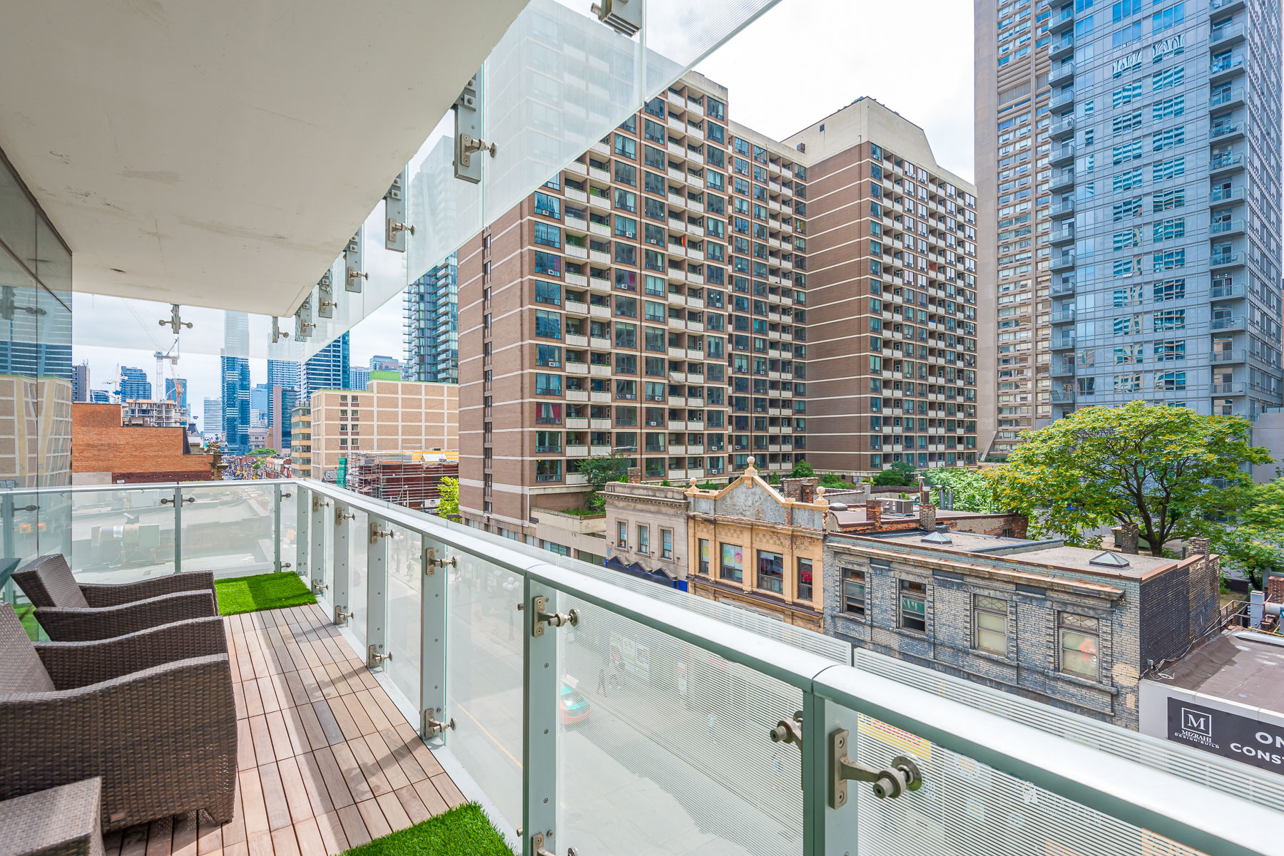 Balcony and wicker chairs - 1 Bloor St E Unit 310 Toronto.