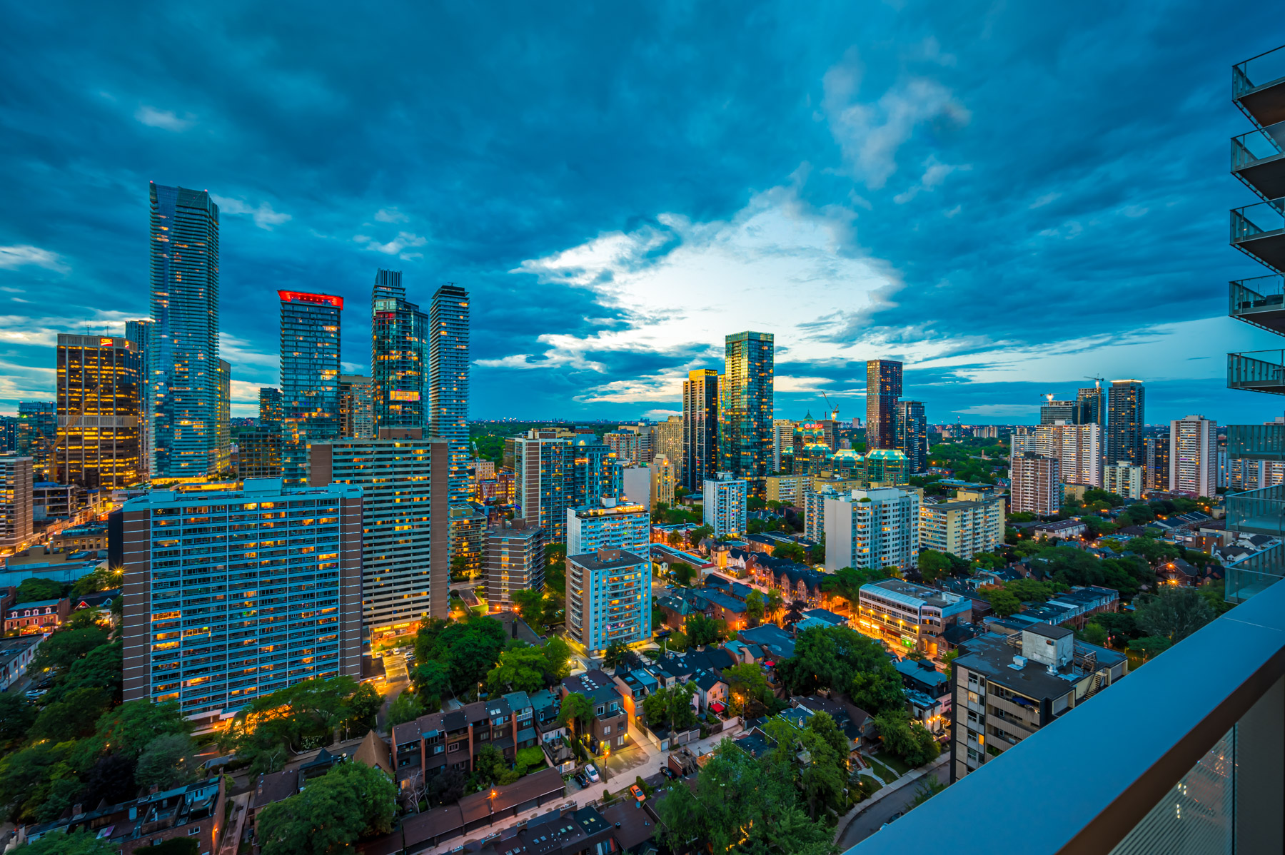 View of Toronto skyline at night from 28 Wellesley St Unit 3009 balcony.