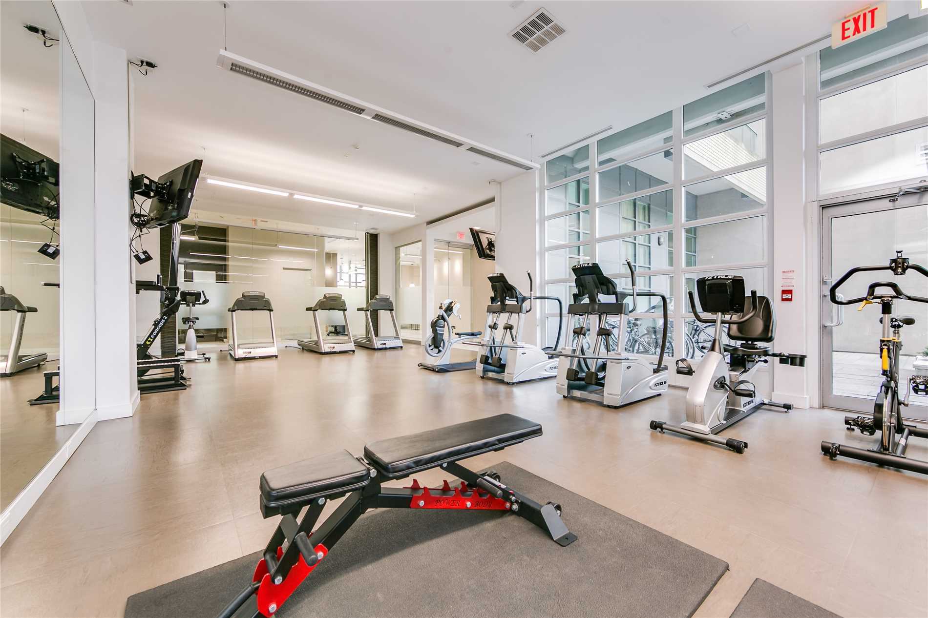 Gym with treadmills and exercise bike at Madison Avenue Lofts.