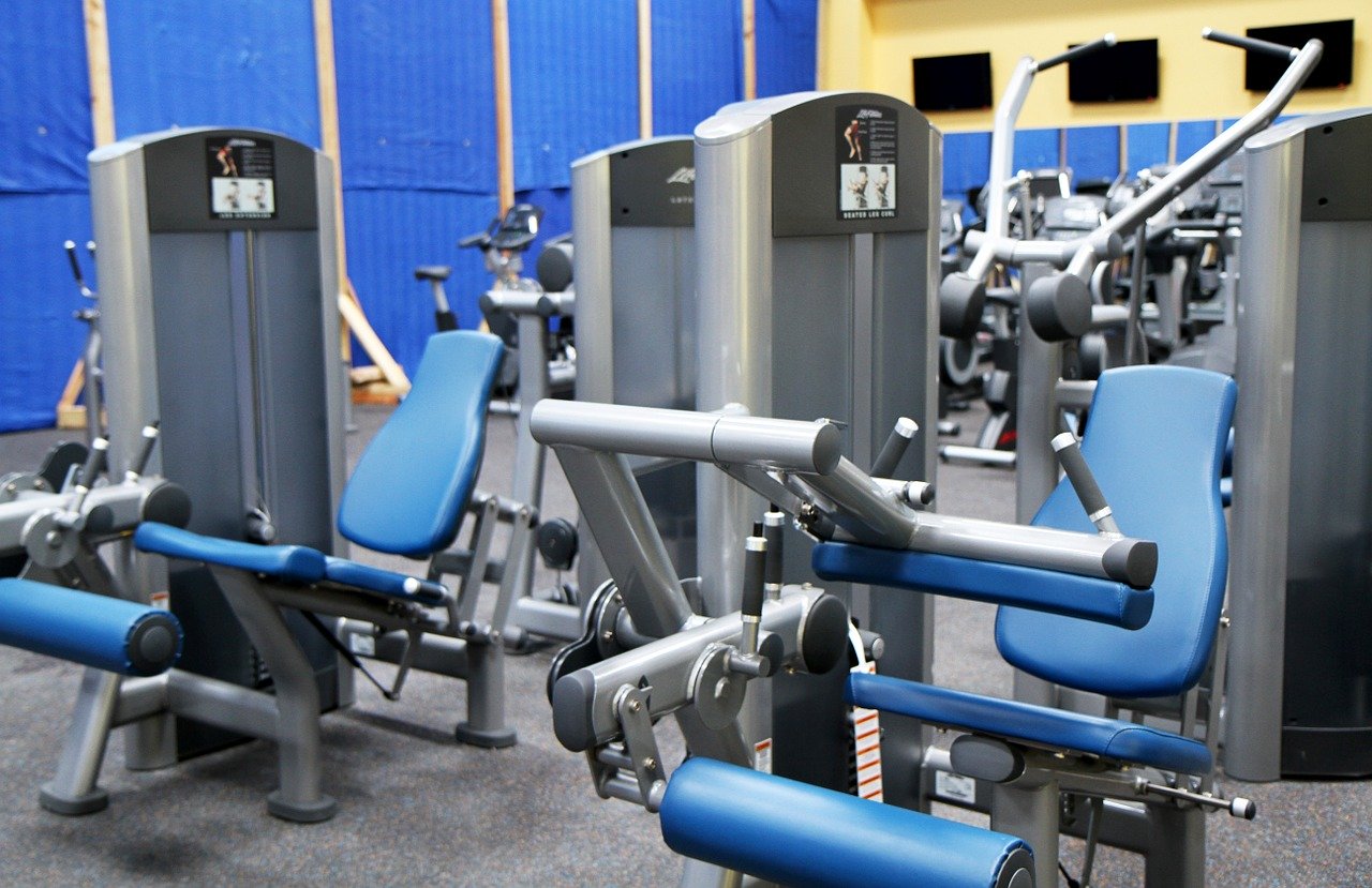 Gym at Twenty Collier with multiple leg press and other equipment.