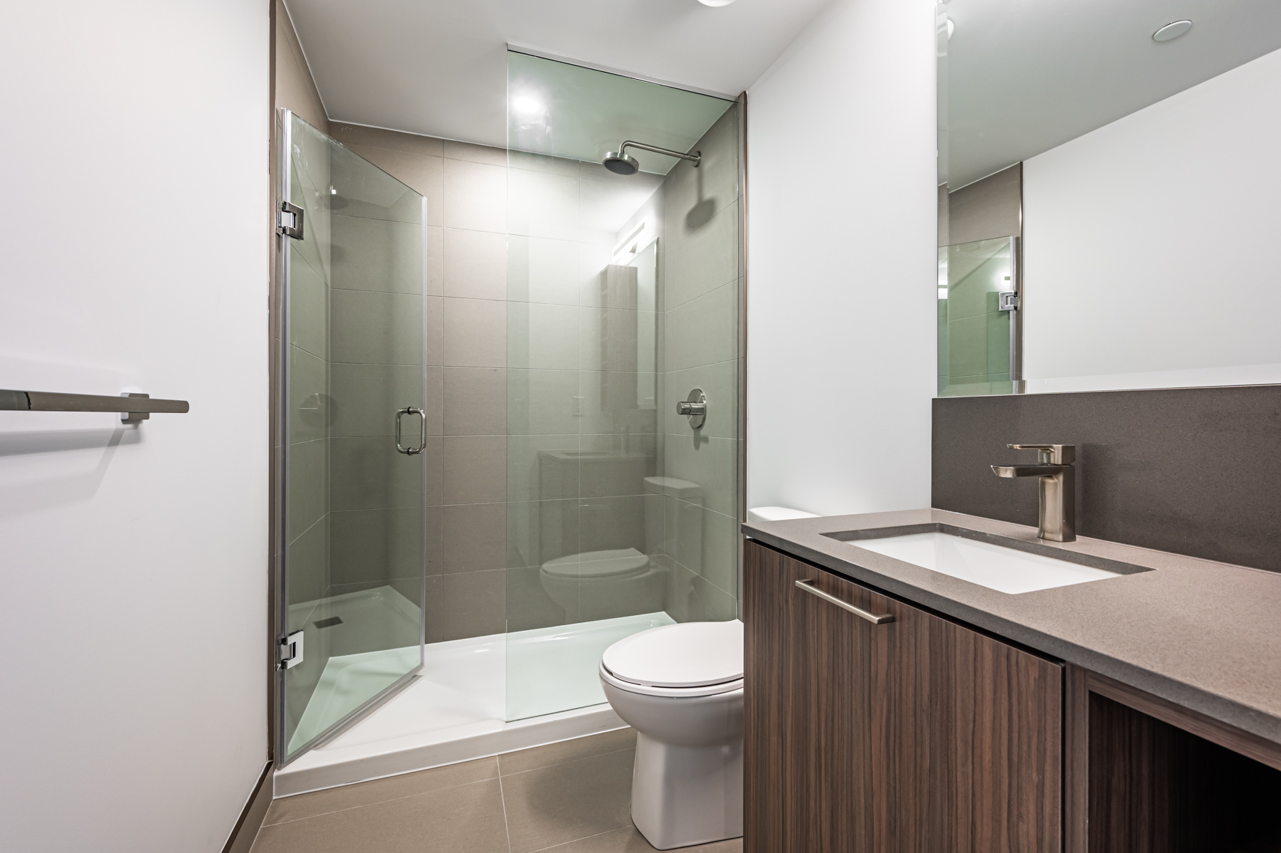 Large walk-in shower with glass doors.