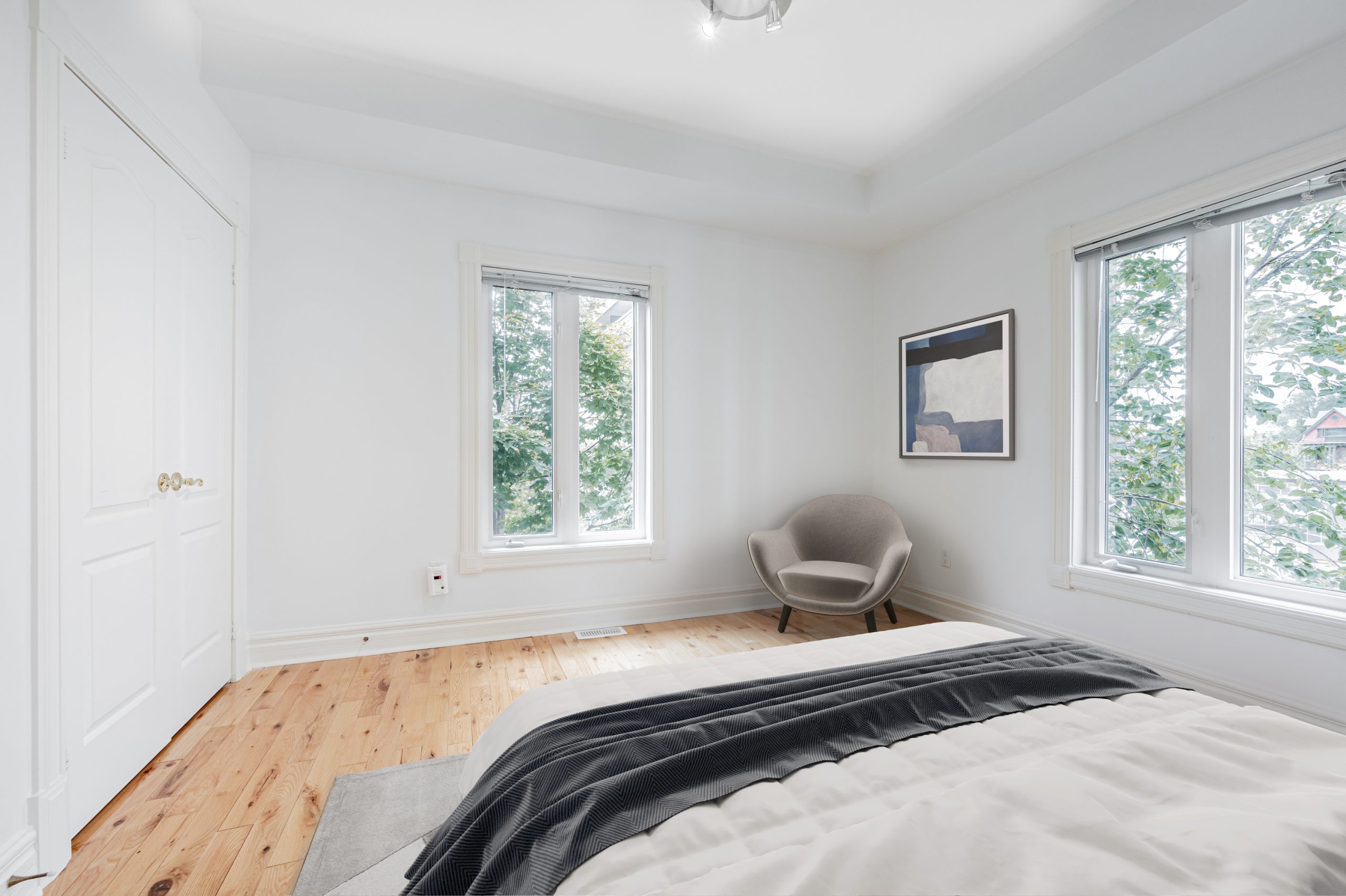 Bedroom windows with trees outside.