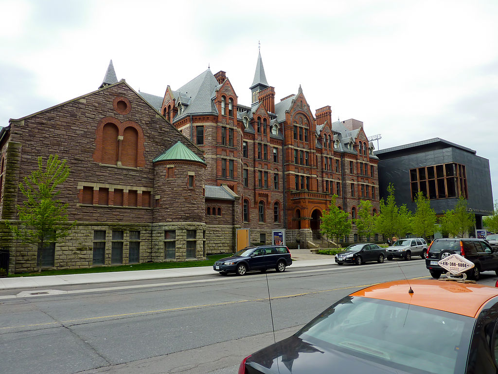 Across-the-street view of The Royal Conservatory of Music on 273 Bloor West; brown building and spires.